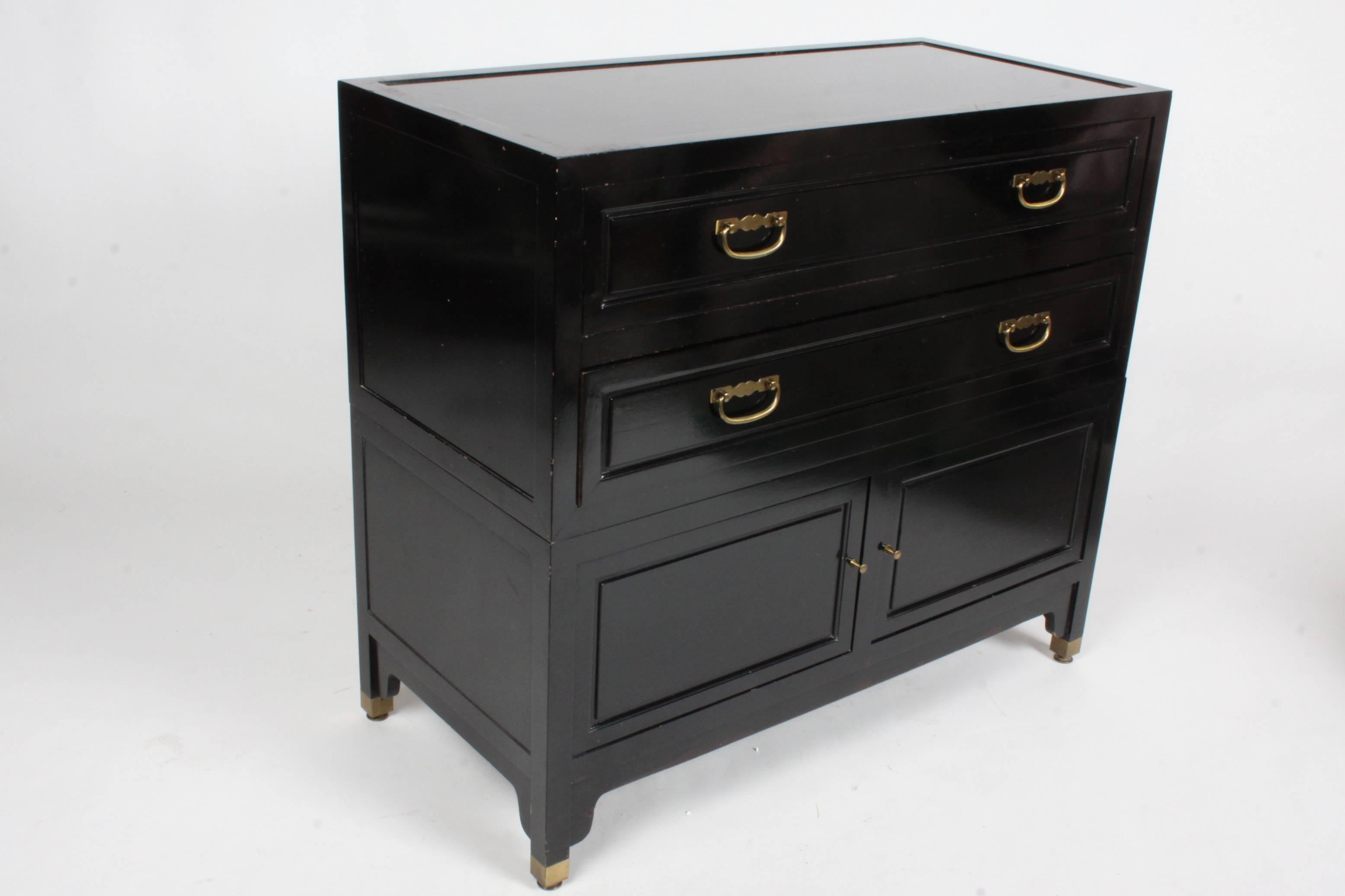 Mid Century Modern Michael Taylor for Baker Furniture Co. Far East Collection black lacquer small chests or nightstands, circa 1960s. Two drawers, top drawer is wide open, second is divided, but sections can be removed. Two lower doors, no shelf.