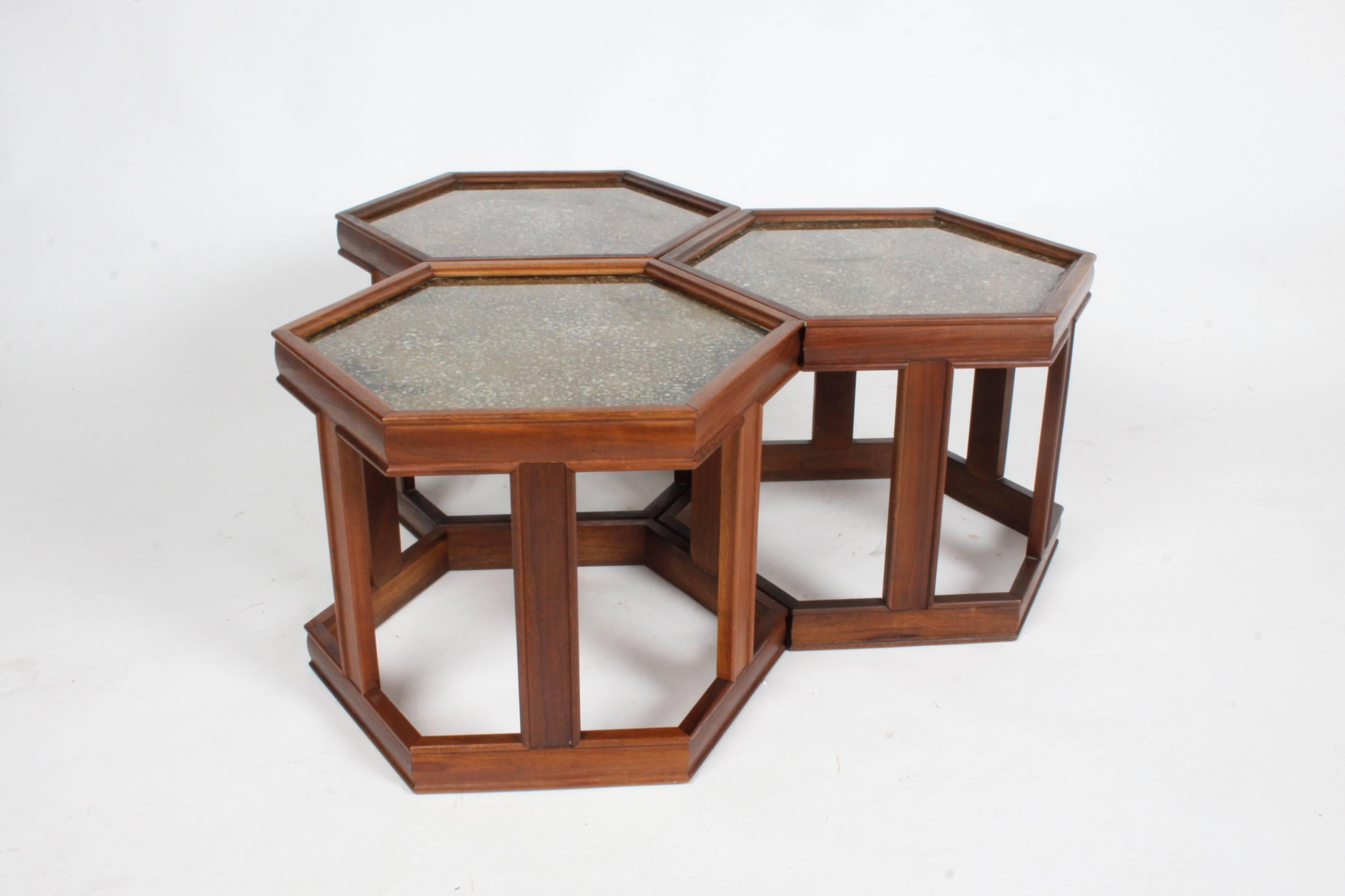 Set of three hexagonal John Keal for Brown Saltman tables that can be used as a group or separated. Frames are teak with enamelled textured design under glass tops. Overall very nice original condition. One table retain label.