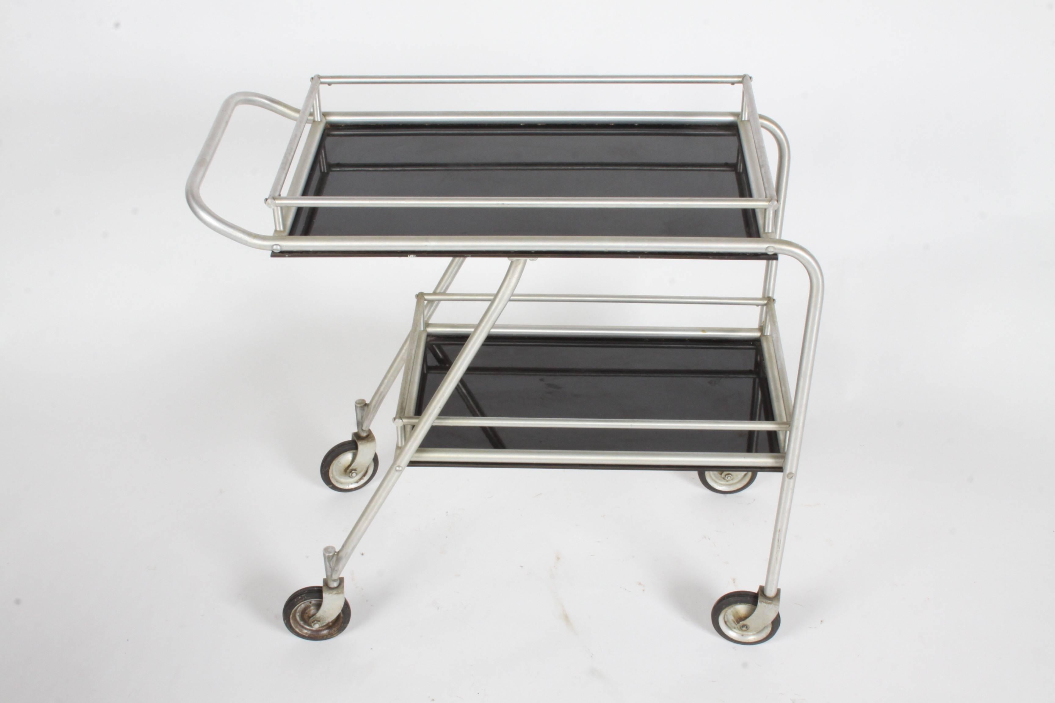 Aero Art aluminum DC3 aircraft rolling bar or serving cart in the style of Warren McArthur. Original condition, may need a little cleaning to the wheels or aluminum if desired. This version has the top and bottom rail. See my other listing for