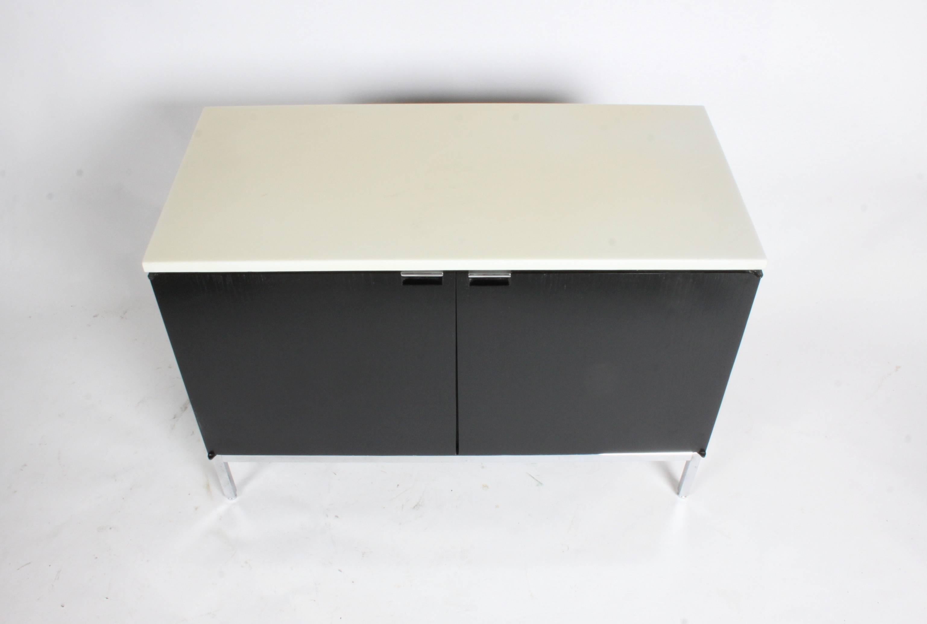 Single Florence Knoll credenza with clear lacquered marble top and ebony stain. Inside width 17 1/2 W x 17 H with adjustable shelves. Very nice example.