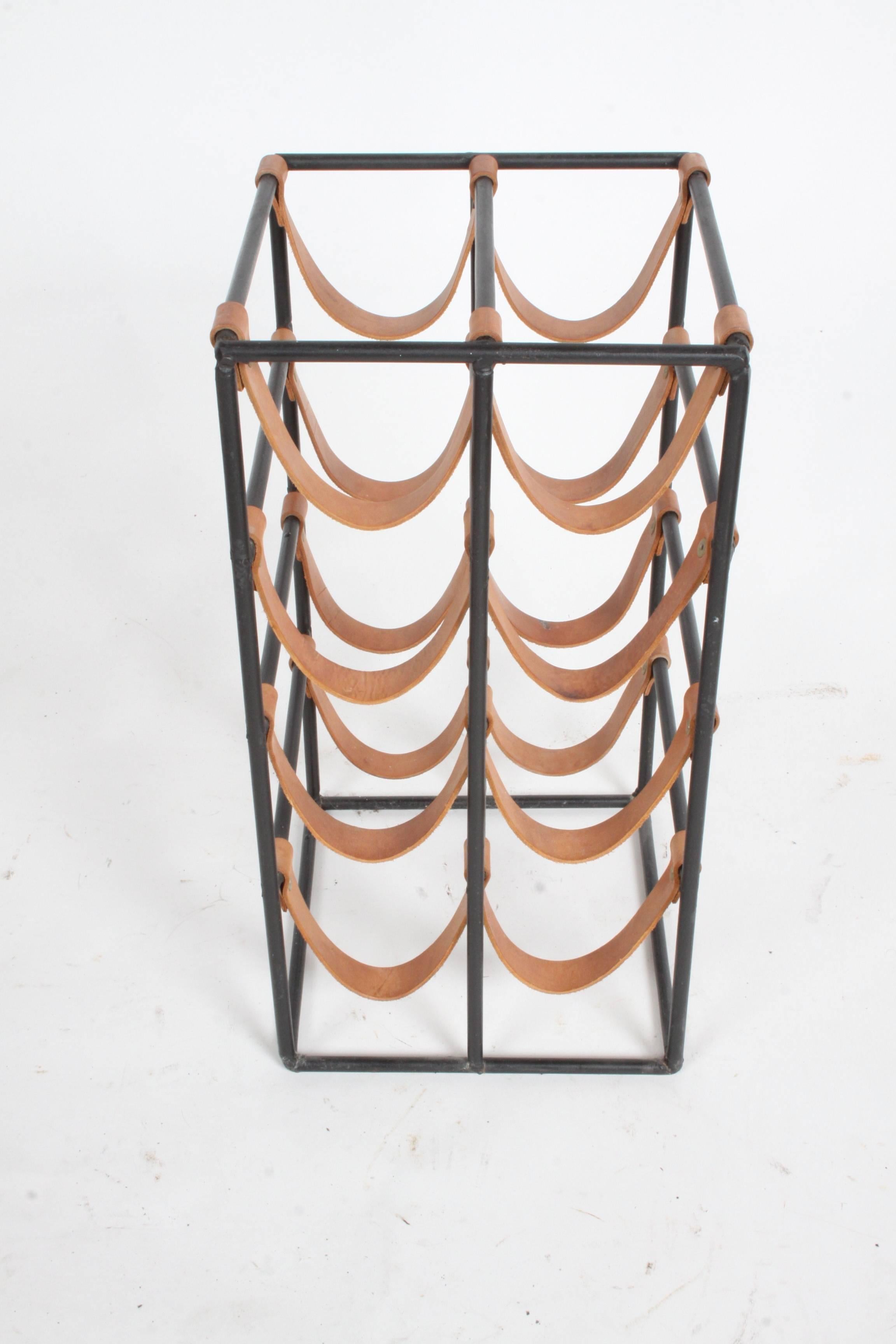 Arthur Umanoff for Shaver Howard 1950s iron and leather strap wine rack. Leather straps are solid, but may have a few old wine stains.