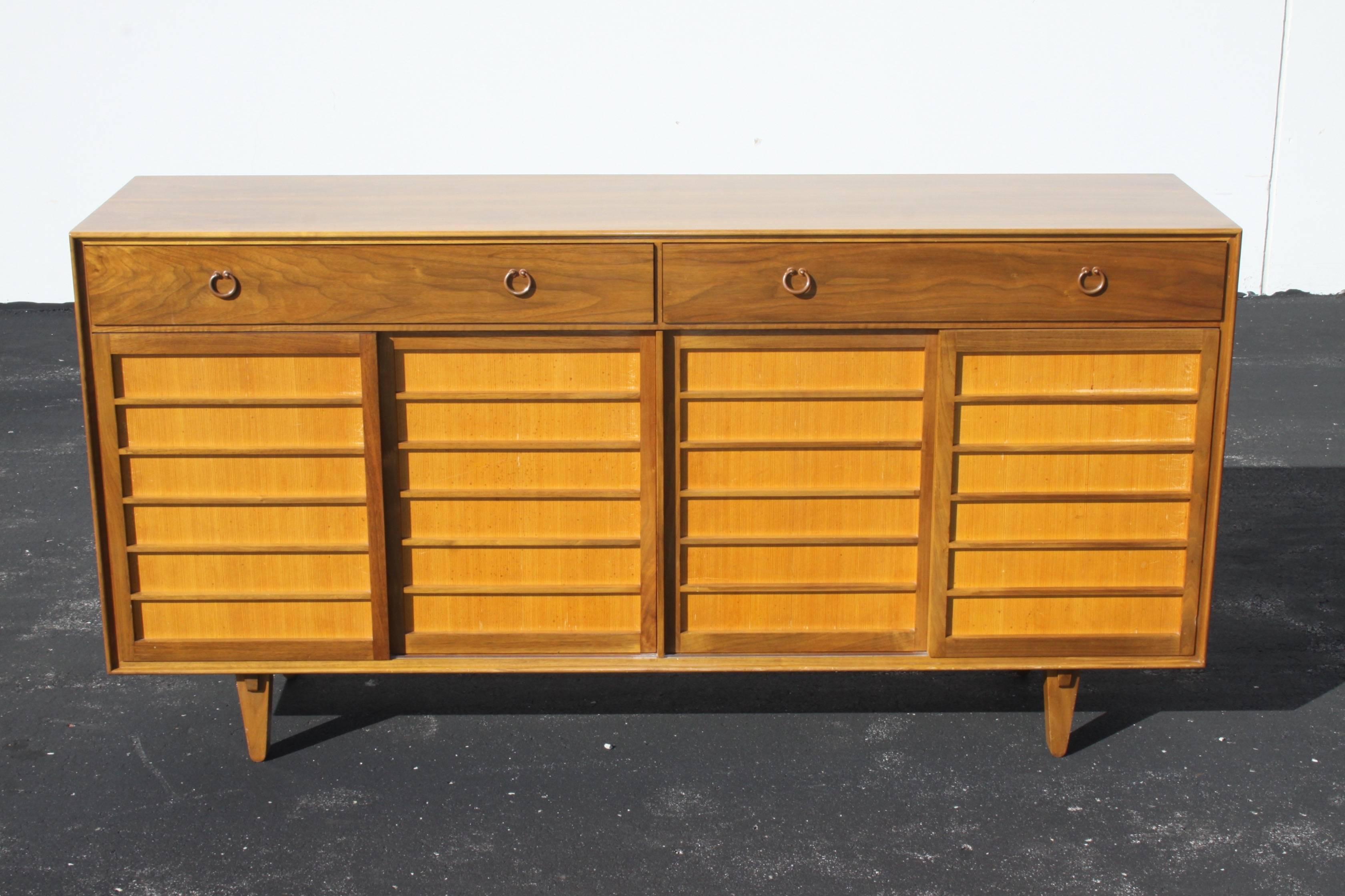 Edward Wormley for Dunbar Japanese influenced sideboard or credenza with beautiful copper forged handles and solid shoji screen style doors. Cabinet is made of walnut, with Japanese pine backed doors. Interior has adjustable clear maple shelves and