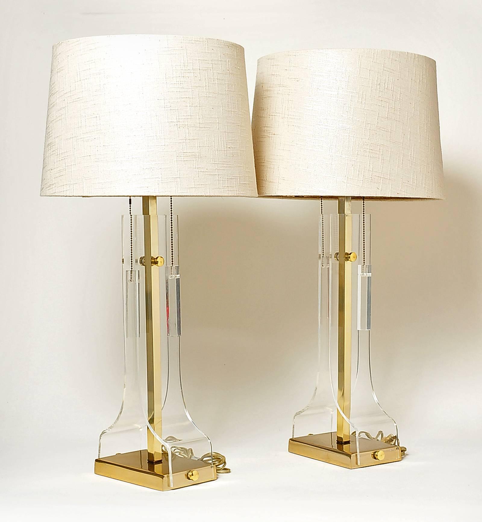 Pair of Laurel Lucite and brass table lamps, circa 1970s. Lucite and brass in very nice condition, only minor scuffs to both. Newer wiring, shades not included.