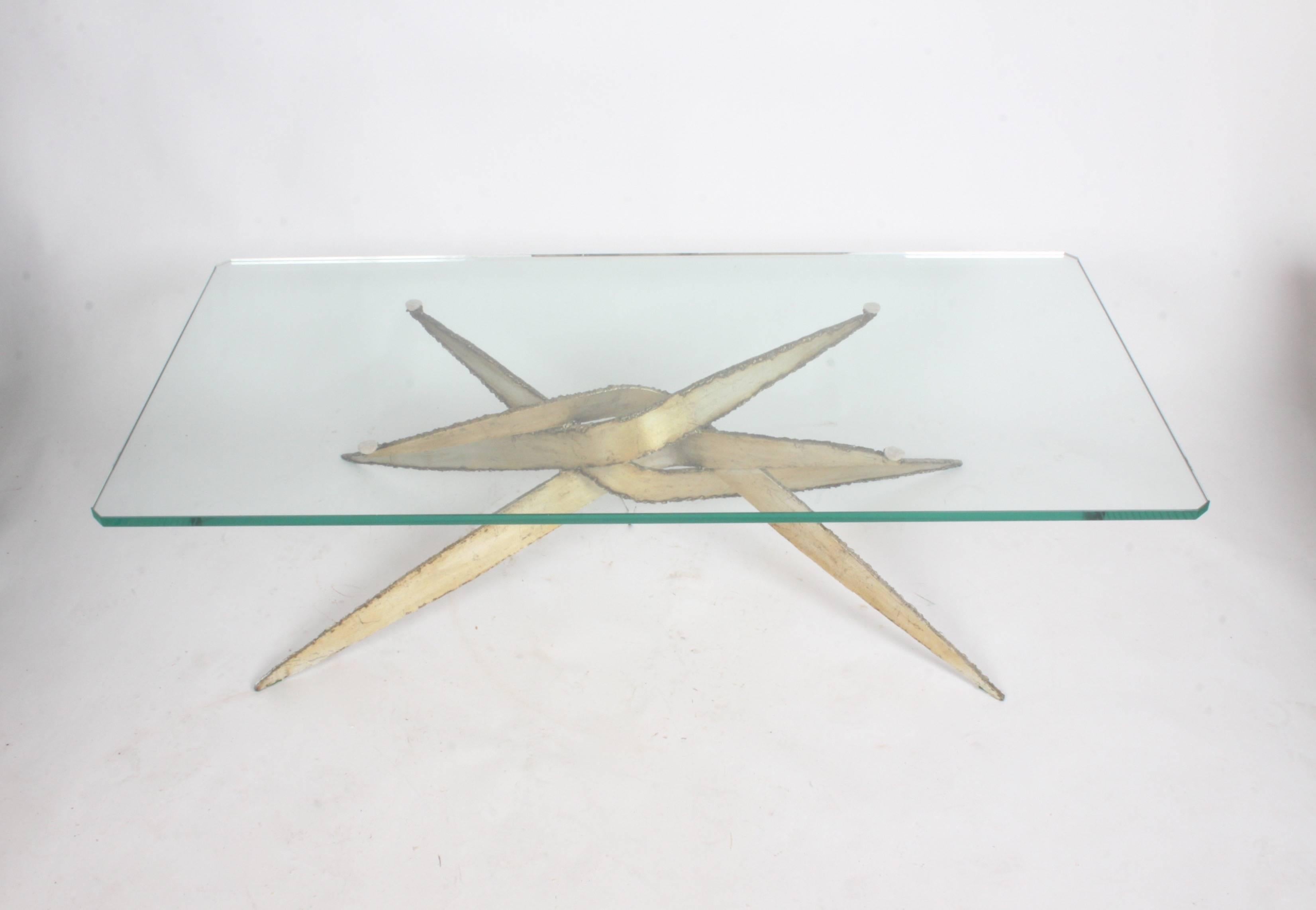 Very sculptural brutalist 1970s torch cut metal base with thick glass top coffee table. Metal base has applied brass / silver patina. This table is stamped Mexico, but is in the style of Silas Seandel or Paul Evans. Purchased from the original owner
