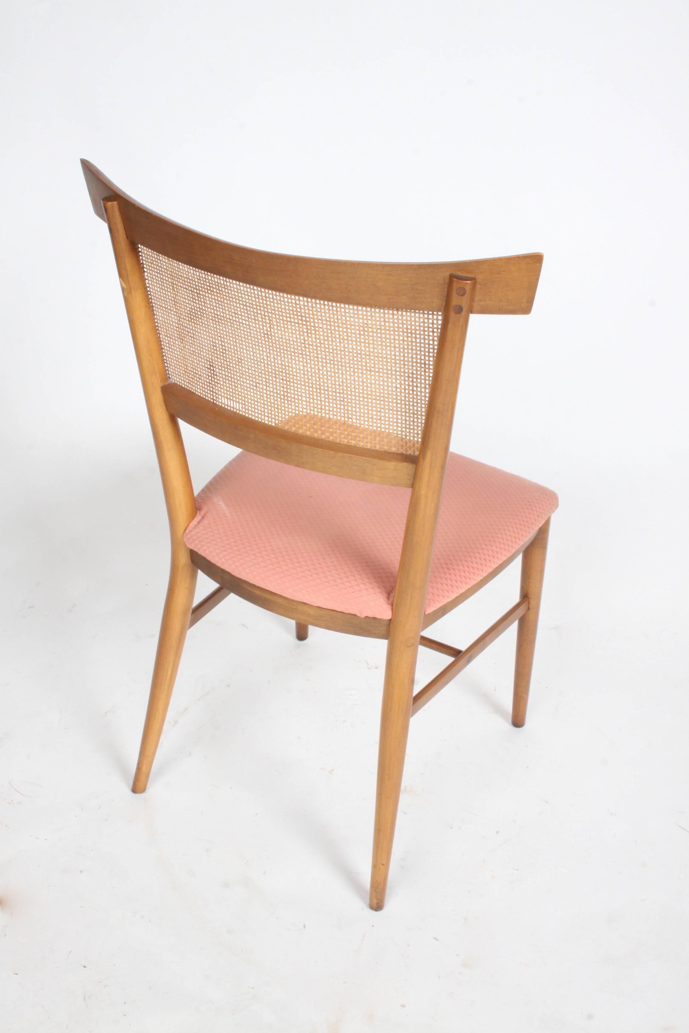 Set of four Paul McCobb for Winchendon Perimeter Group bow tie dining chairs in original finish. Upholstery has stains, not original. Some minor loss to cane, can be repaired for additional cost. Also, set can be refinished in a dark espresso like
