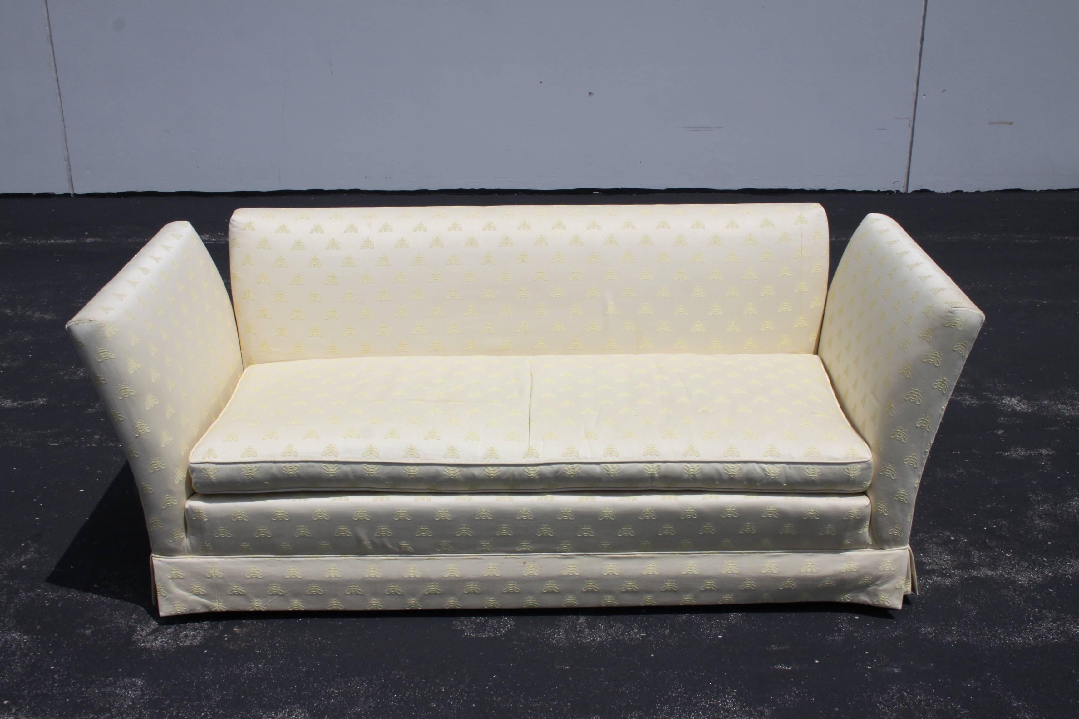 Baker Furniture Knole open-arm settee or loveseat sofa, circa 1970s. This sofa has been reupholstered at some point, upholstery does show wear and stains. Recommend reupholstery. Original brass acorns included. This is very much in the style of