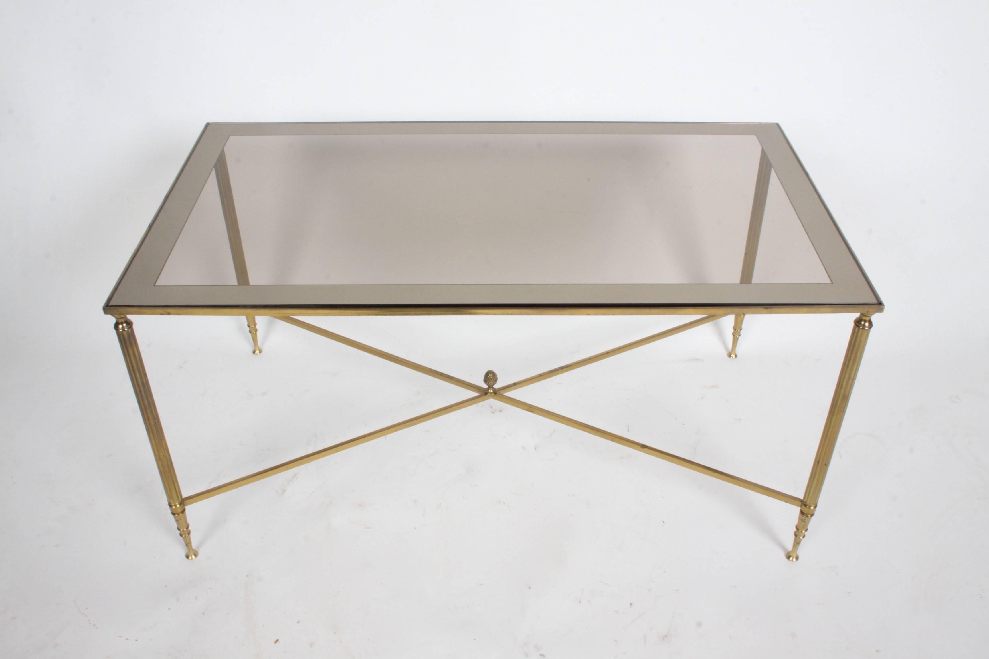 In the style of Jansen, this Neo-classical three part bronze fluted frame cocktail table with mirrored edged bronze glass tops, end pieces can be used as demilune side tables. Patina to brass, several scratches to main table glass.

 The main table