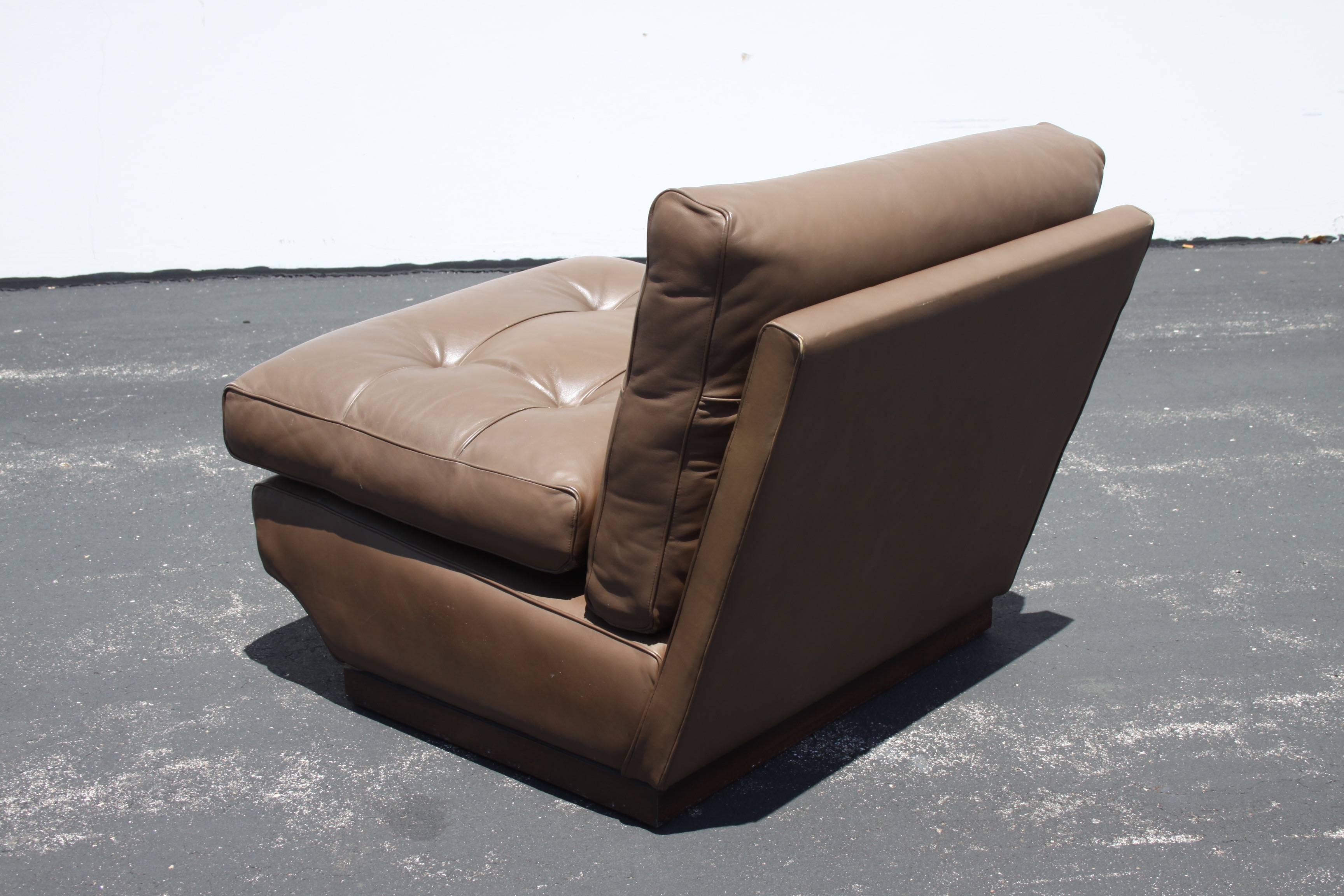 Pair of Mario Bellini brown leather tufted lounge chairs for B&B Italia on wood frames, designed in the 1960s. Imported by Atelier International, LTD. Leather has minor scuffs, overall very nice condition.