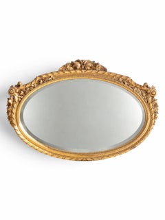 Coppia di specchi in legno dorato con stemmi intagliati con motivi floreali e fogliati decorati