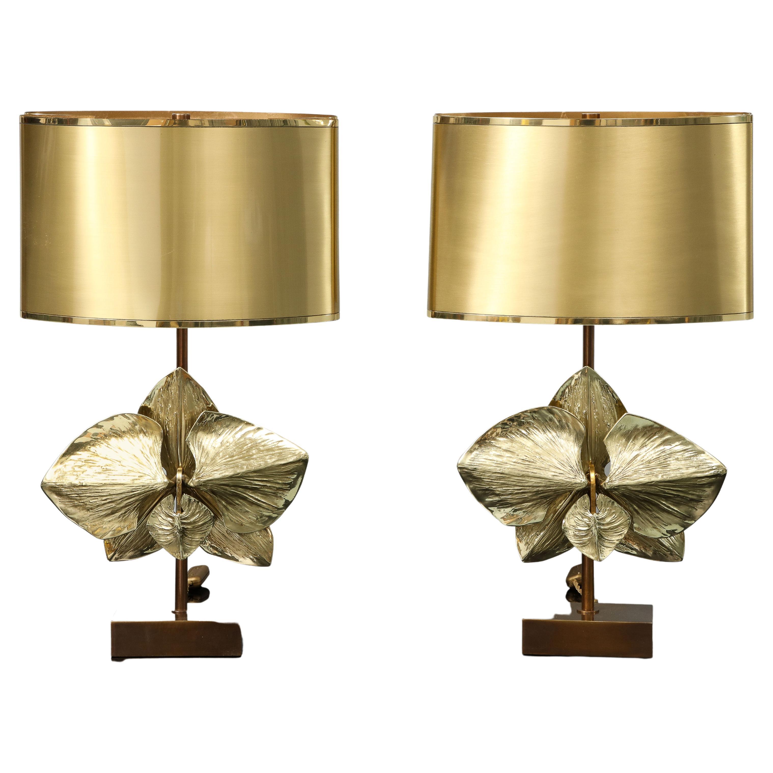 This pair of table lamps made by Maison Charles in its Atelier in Paris in the 1970's is referenced in its catalogue. Model 2155. It is signed and made in bronze. The shade is in brass with two tones of gold and the 2 halves of the shades are joined
