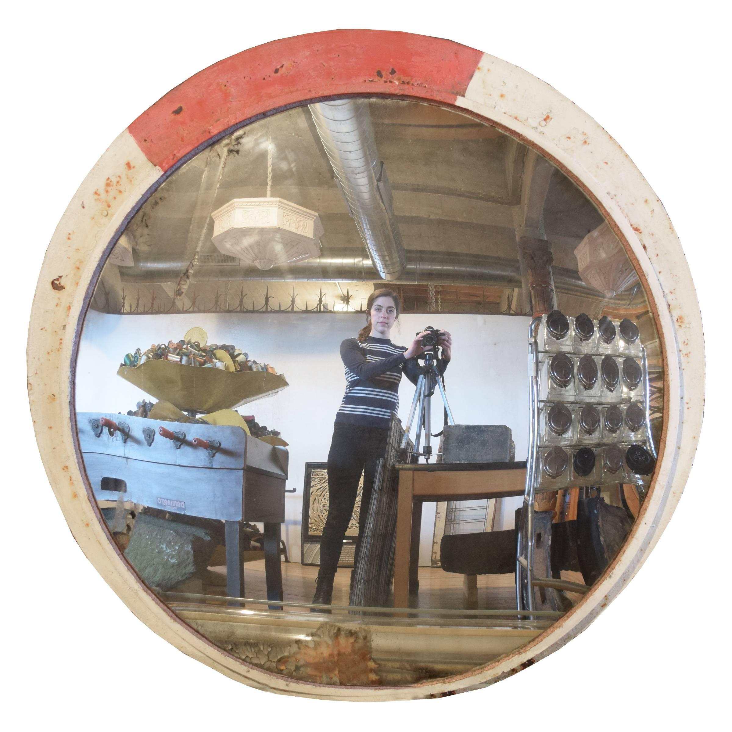 A large convex mirror with great patina in a red and white painted iron frame, once hung on a winding mountain road in the Czech Republic. Multiple available with varying painted frames.