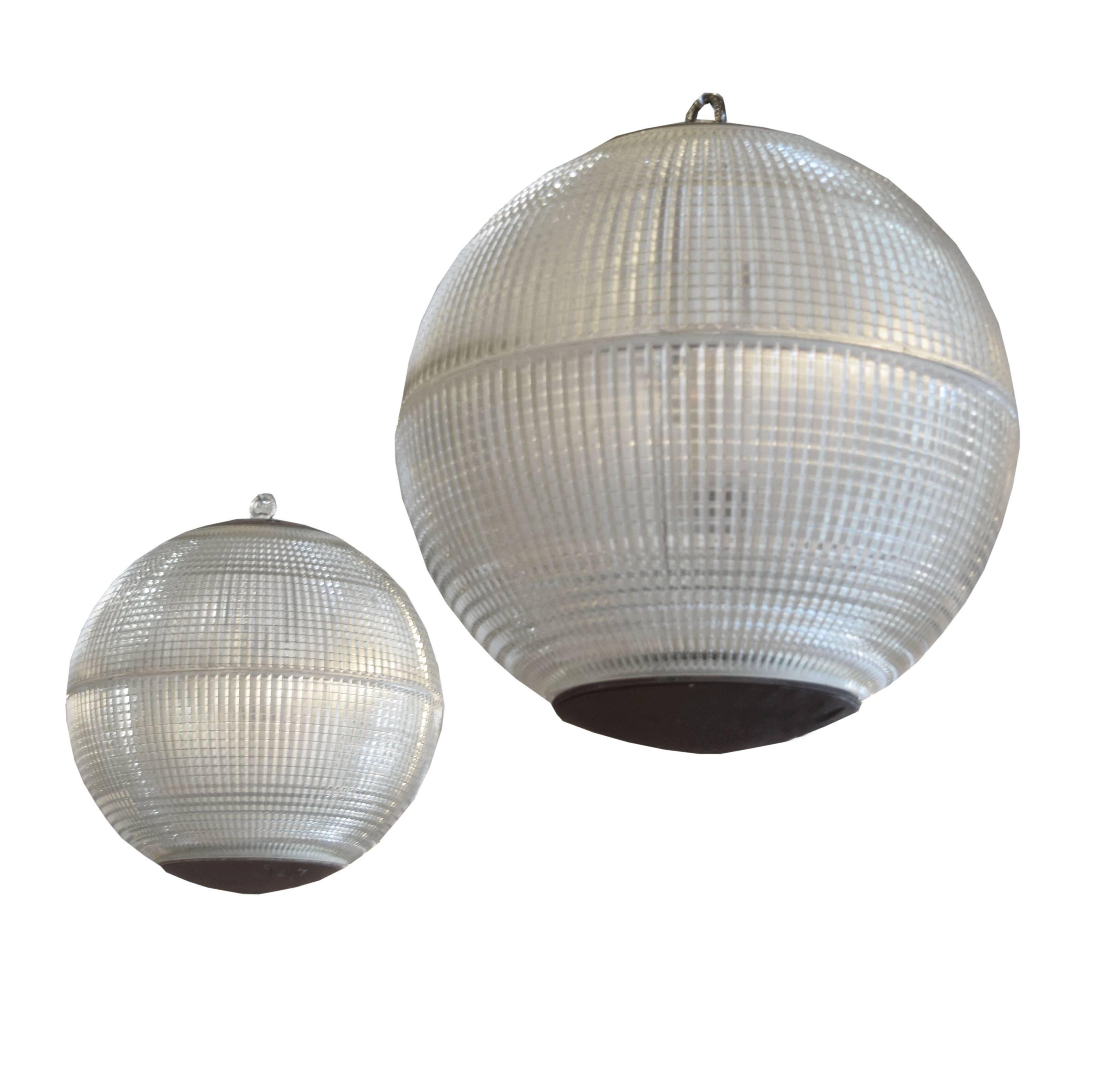 Spherical Holophane pendant, originally from a street light in Paris, France with prismatic glass shades that provide a combination of even uplight and downlight, circa 1960.

Require re-wiring.