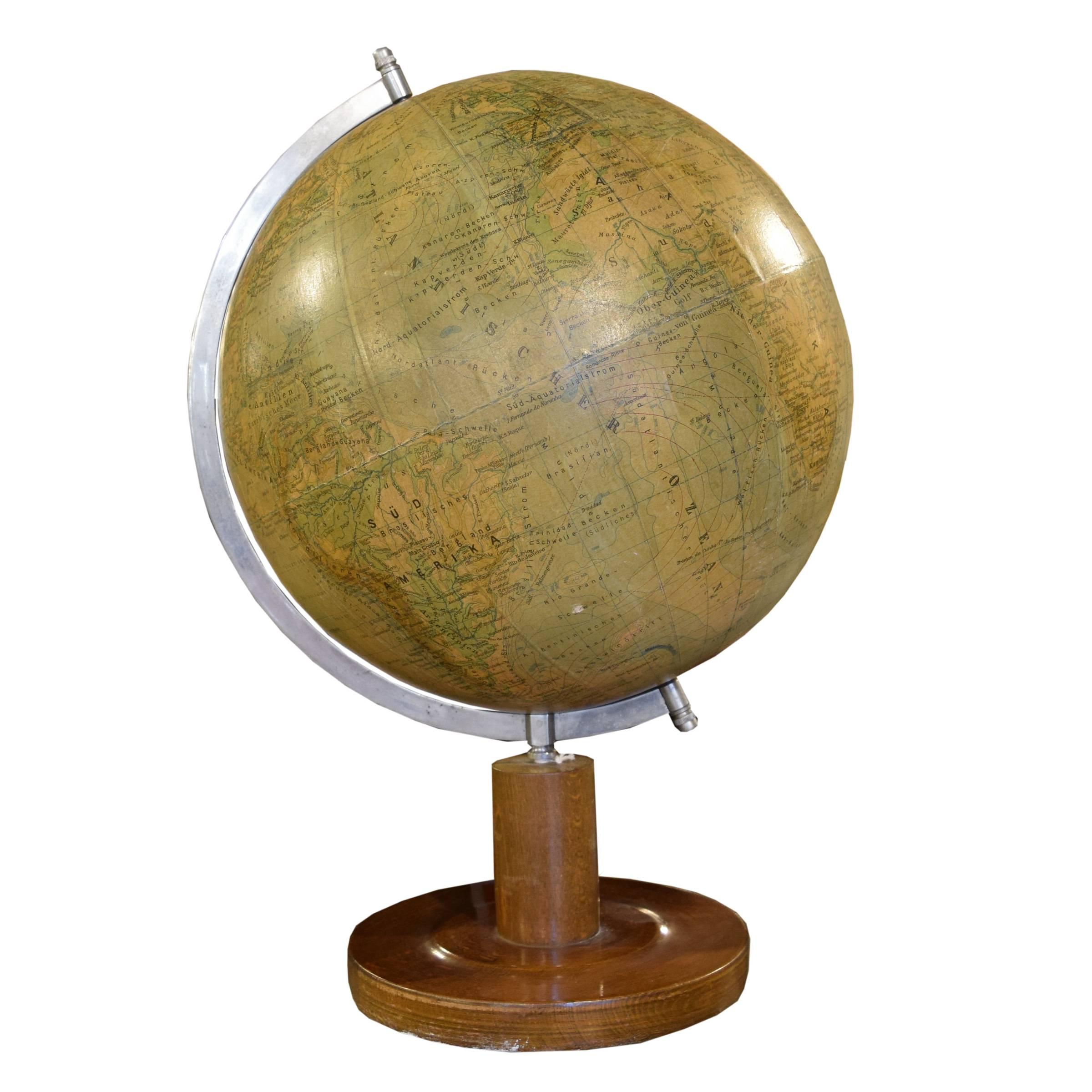 A very nice German spinning globe mounted on a circular wood stand, early 20th century.
 