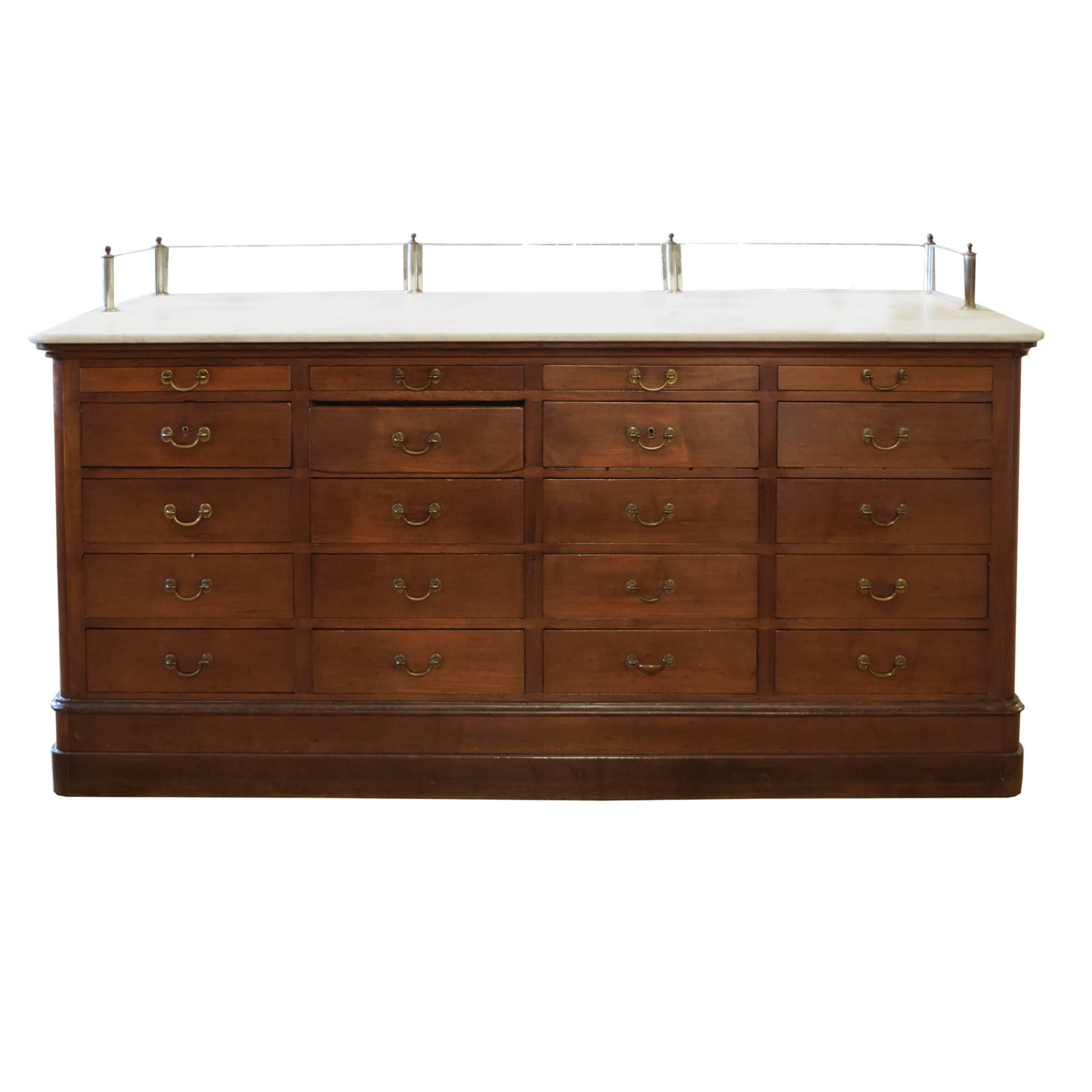 The best Italian wood shop counter with paneled sides, three locking front glass doors, 20 drawers with brass handles and a glass rail along three sides of the counter's marble top.

Counter height is 38