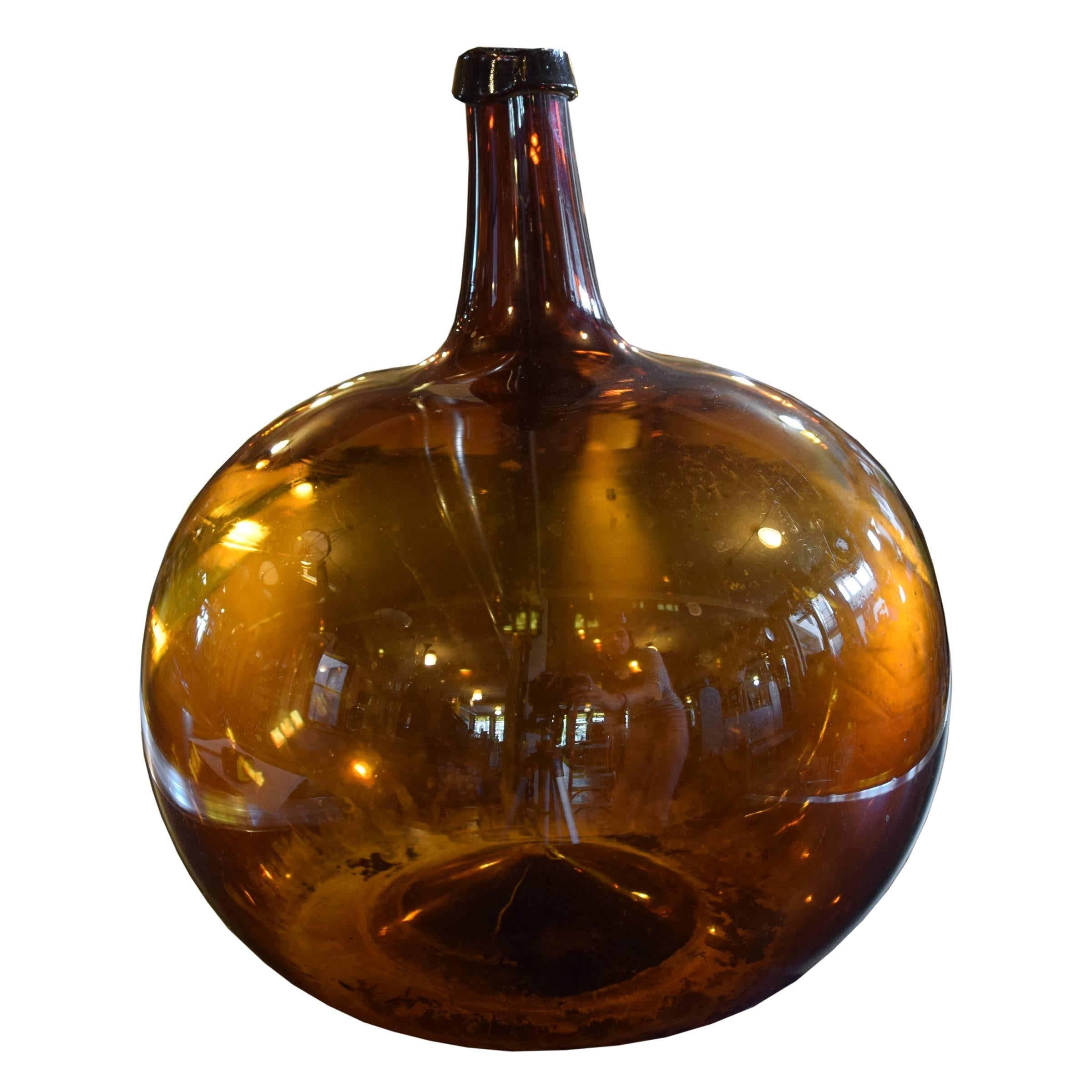 Fantastic French handblown glass wine vessel with a beautiful amber color, 19th century. Many available. Dimensions vary, each unique.