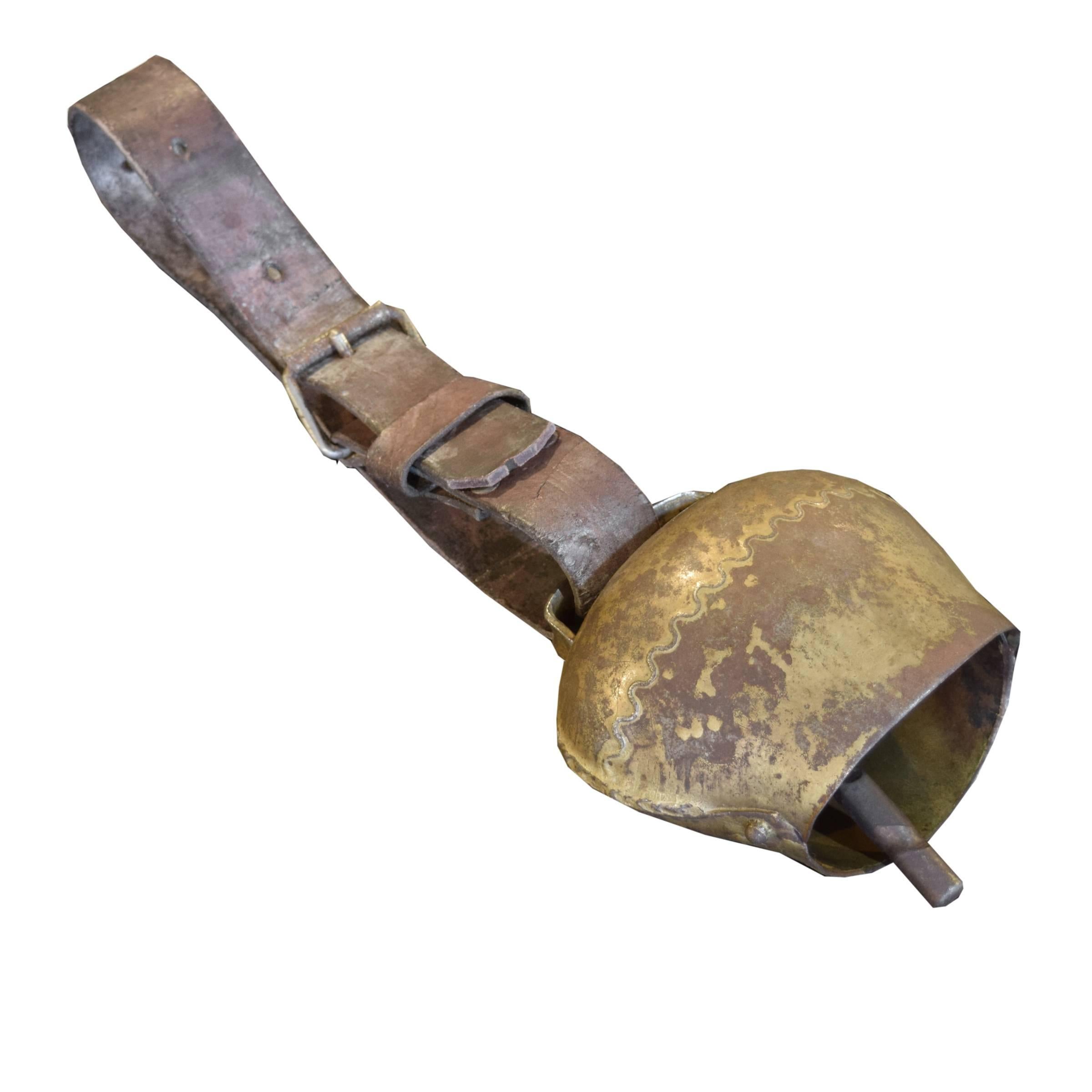 A charming Swiss cowbell with a gilt iron bowl and clapper and an iron buckle on an adjustable leather strap with great patina.
 