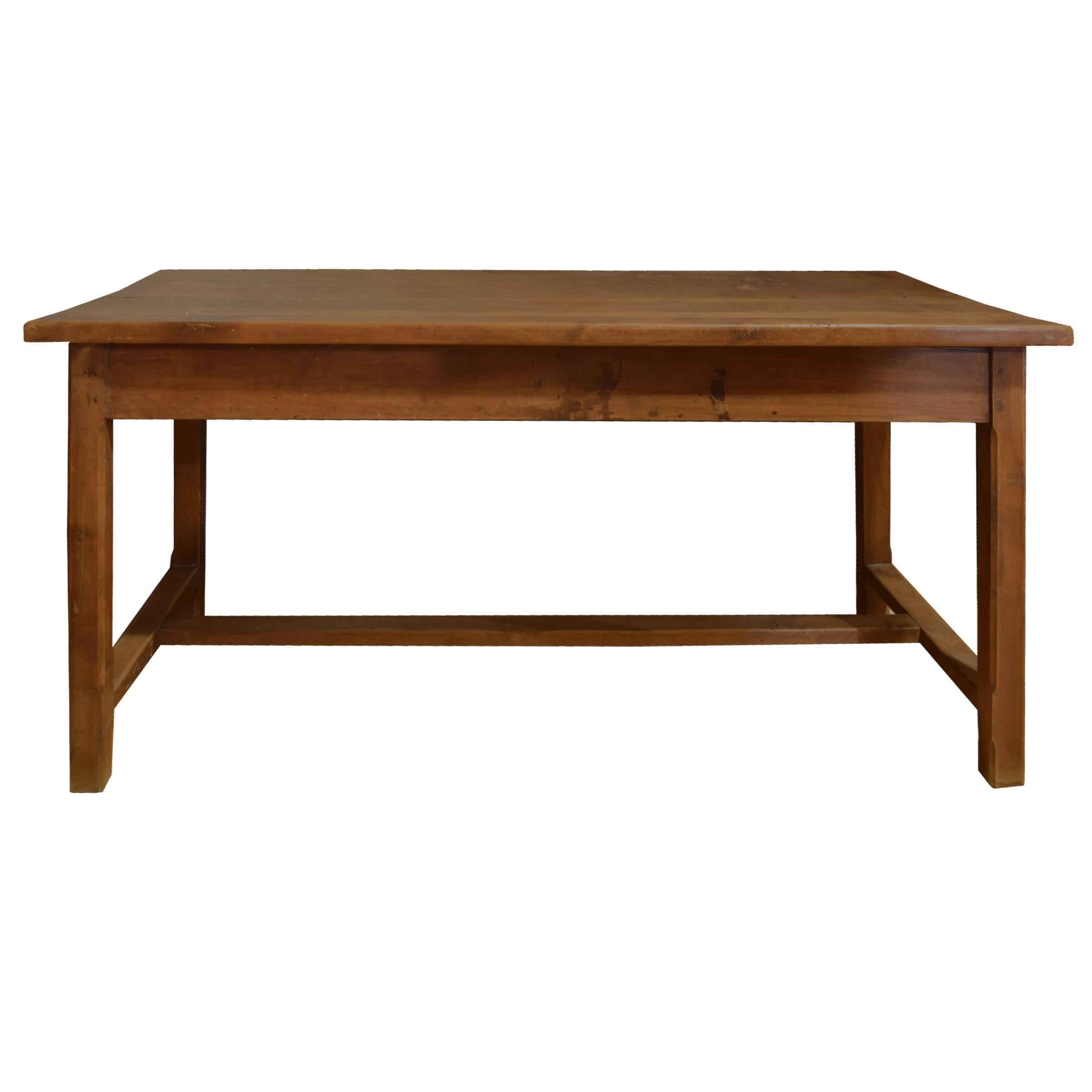 A French walnut farm table with a drawer on each end with brass hardware, stretchers across two legs, a central trestle, with great patina, early 20th century.