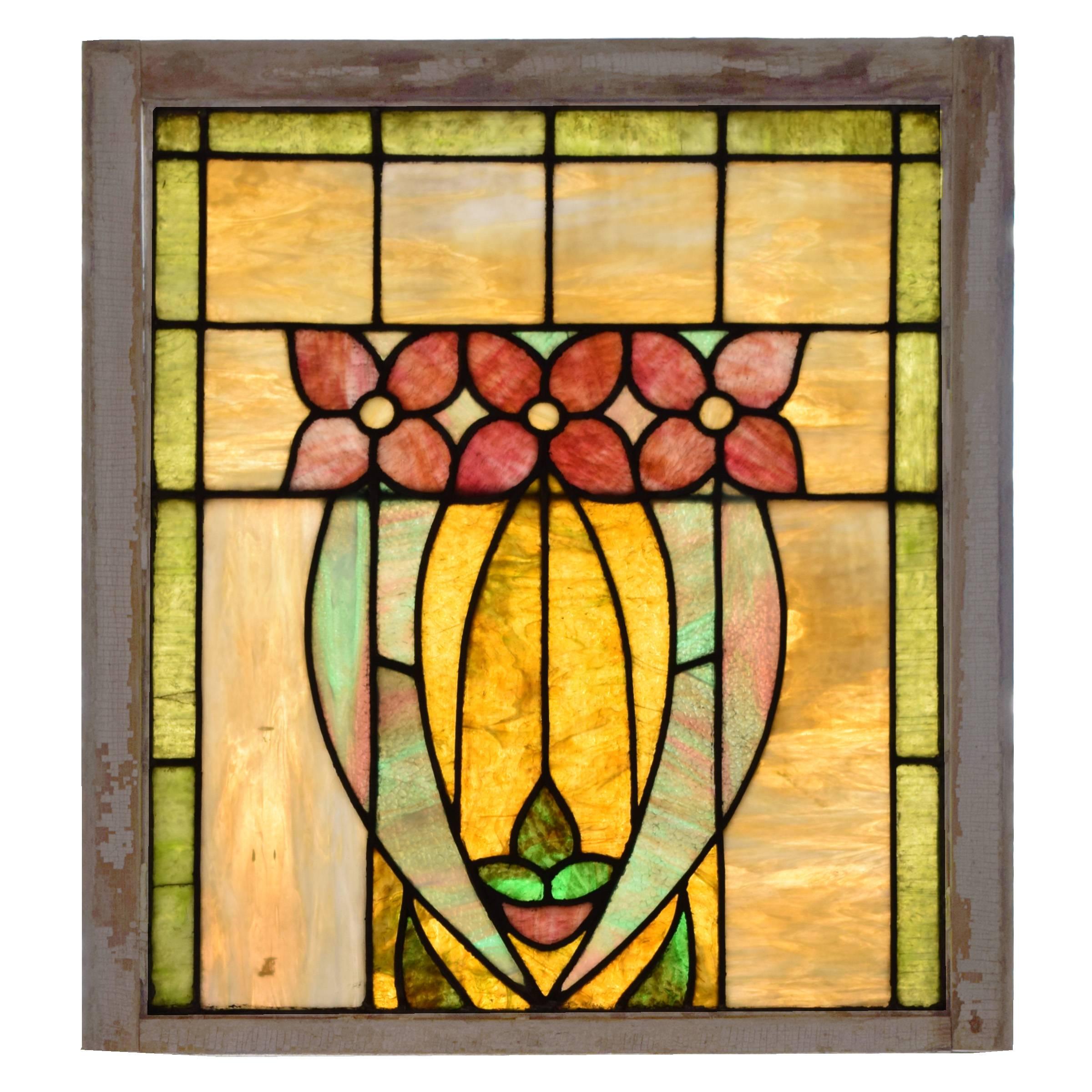 An American two-panel stained glass window with pearlescent glass depicting a floral scene, in wood frames, circa 1910.