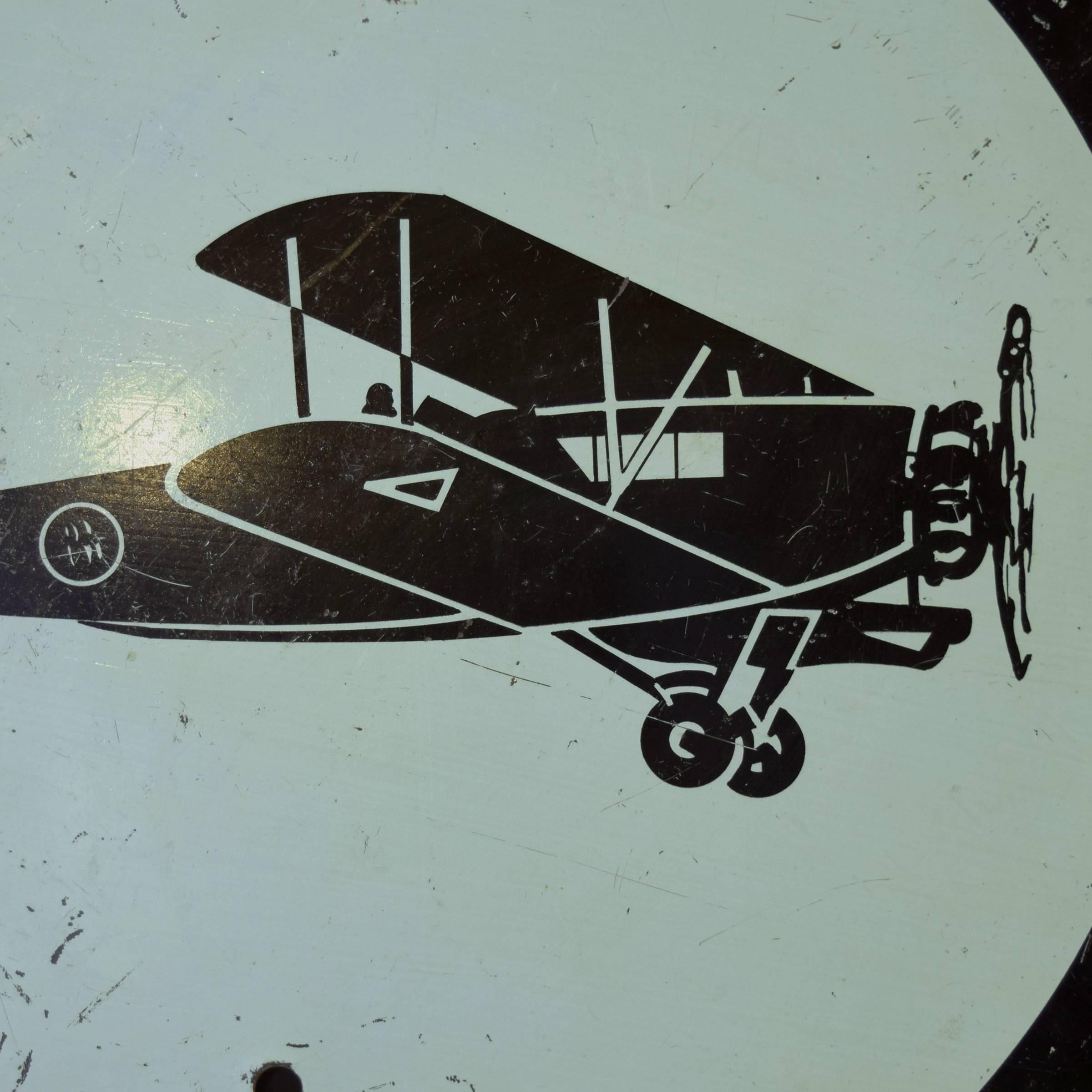 An extremely rare circular metal sign depicting an airplane from the 1933 Chicago World's Fair, manufactured by the Green Duck Metal Stamping Company of Chicago. These signs were places on street lamps around the fair, which focused on the