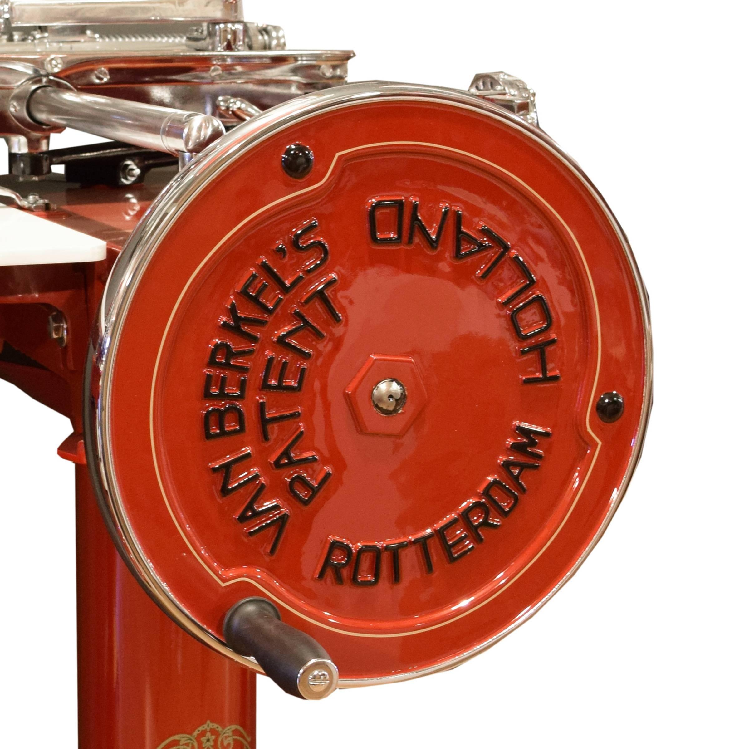 A rare Berkel model 7 meat slicer in a red high gloss enamel with gold pinstriping, manufactured in Rotterdam, Holland. This model, manufactured from 1922-1928, is flywheel operated and features 15 different slicing thicknesses and a blade
