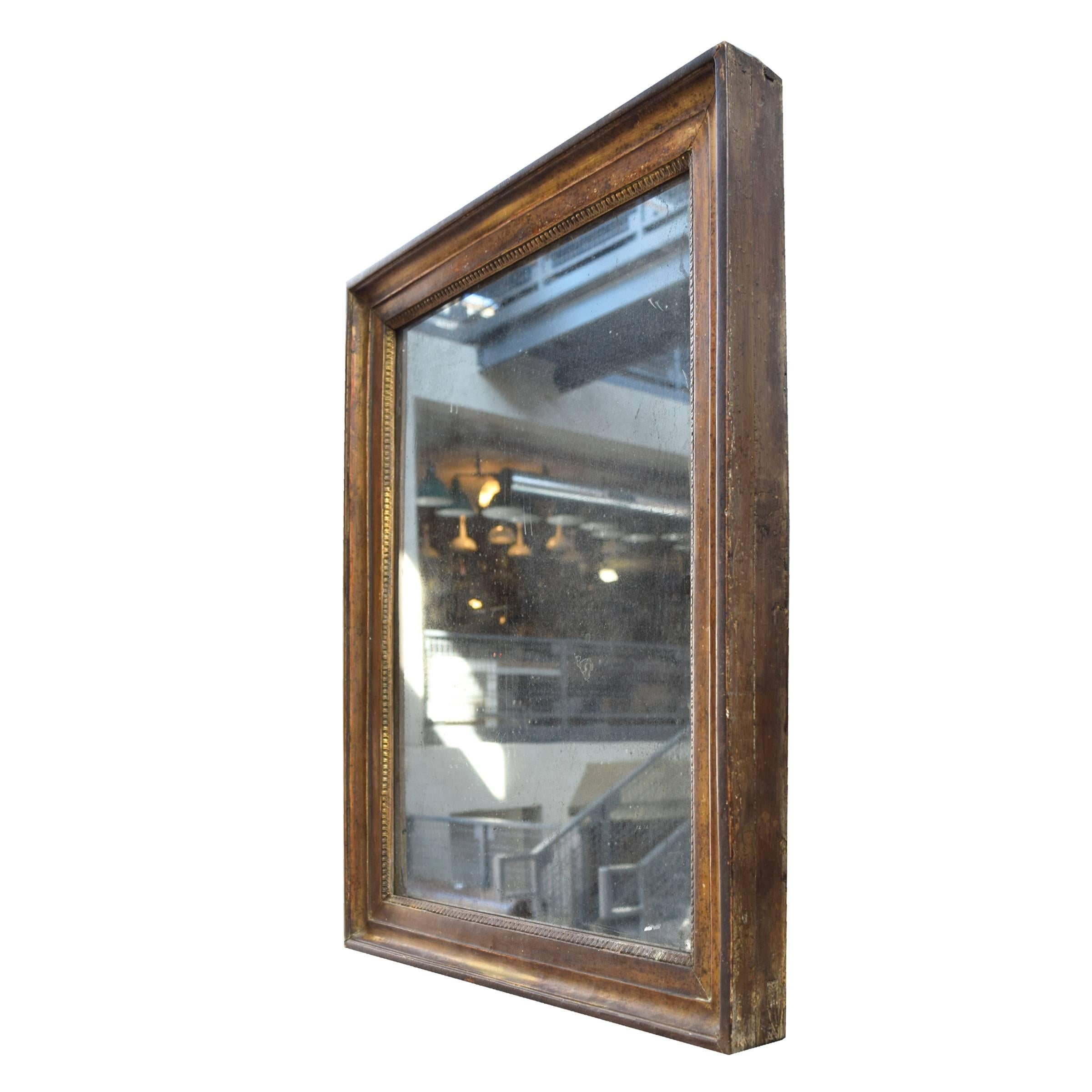 A French 19th century gilt frame with original mirror. Wonderful patina!
   