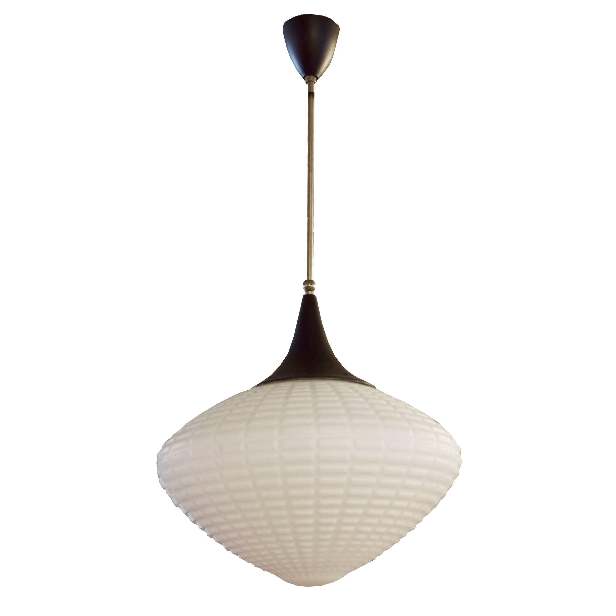 A Mid-Century Czech pendant light fixture with a brass downrod and opaque molded glass shade. Many available. Need to be re-wired.
 