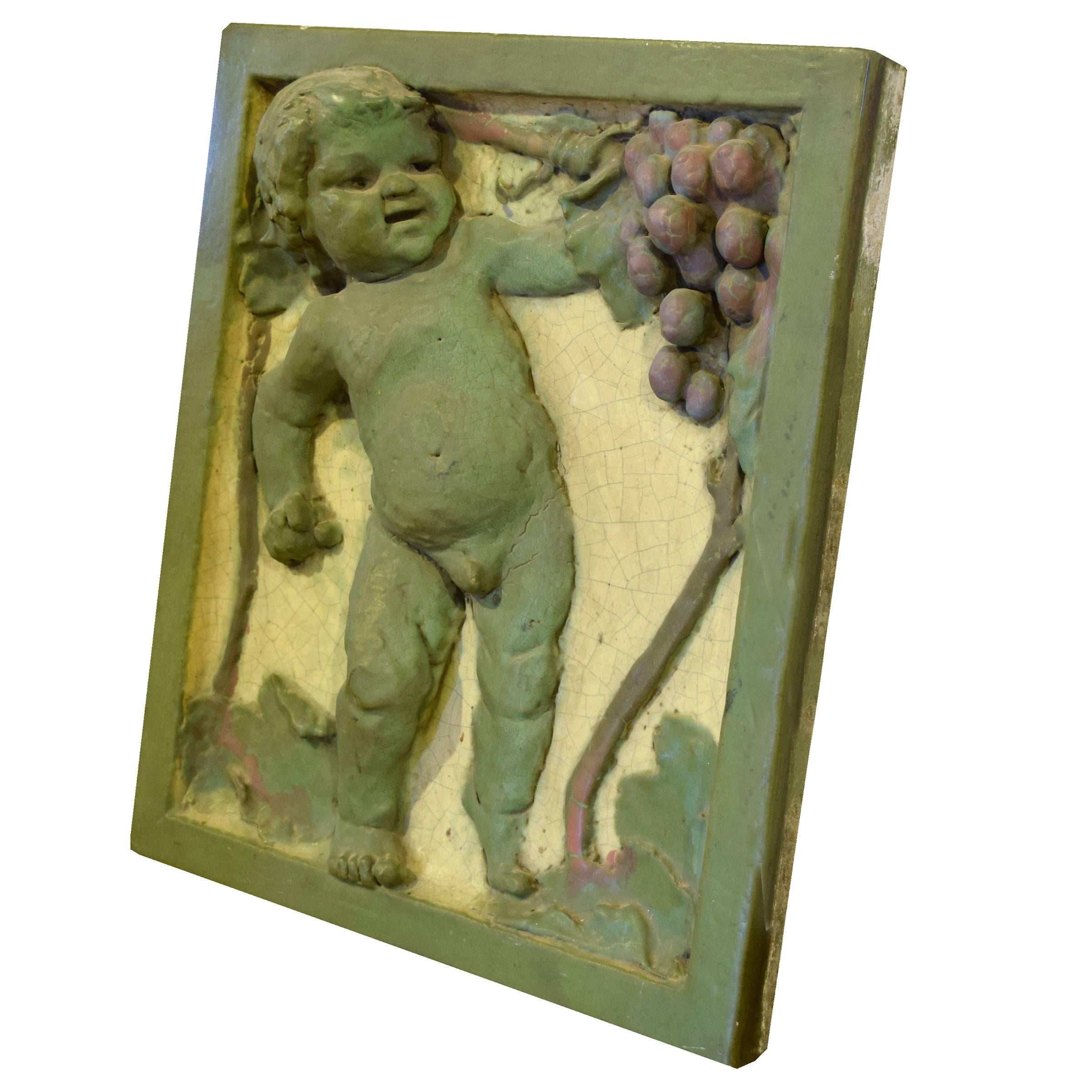 American polychrome interior terracotta tile by the Rookwood Pottery Co. depicting a young boy grasping grapes, from the German Grille in the LaSalle Hotel in Chicago, Il. The LaSalle hotel was built in 1908 by Holabird & Roche and was razed in