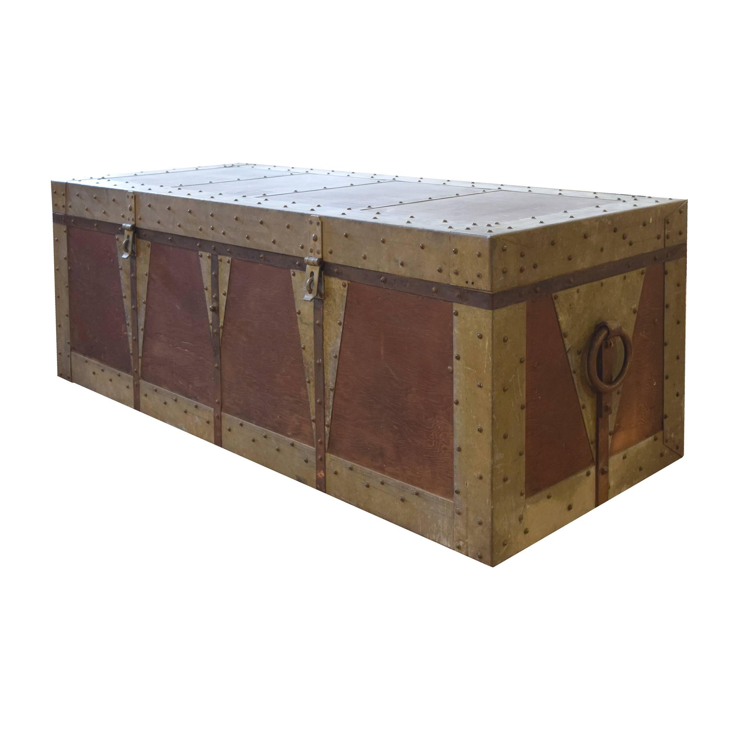 A very cool American wood and metal magician's trunk with two front latches and a handle on each end, as well as a removable interior top drawer.