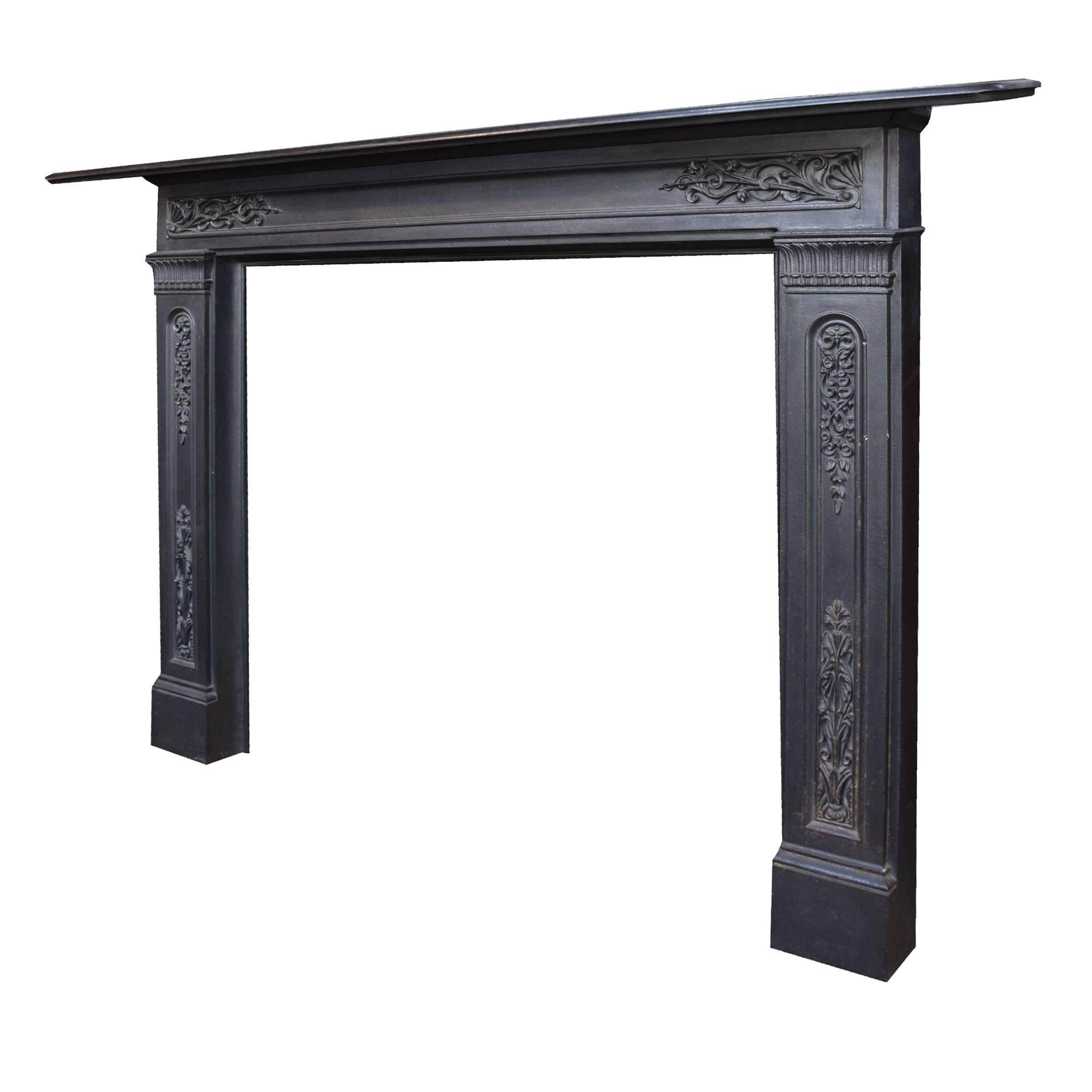 An English polished cast iron fireplace mantel with a floral and vine motif.