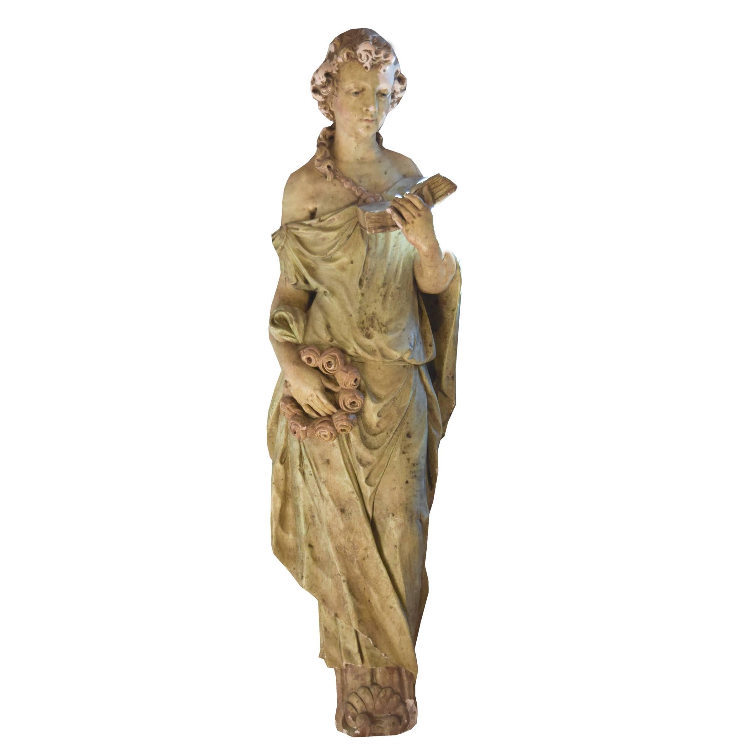 A pair of American painted composition wall hung statues depicting women draped in fabric, circa 1900.
