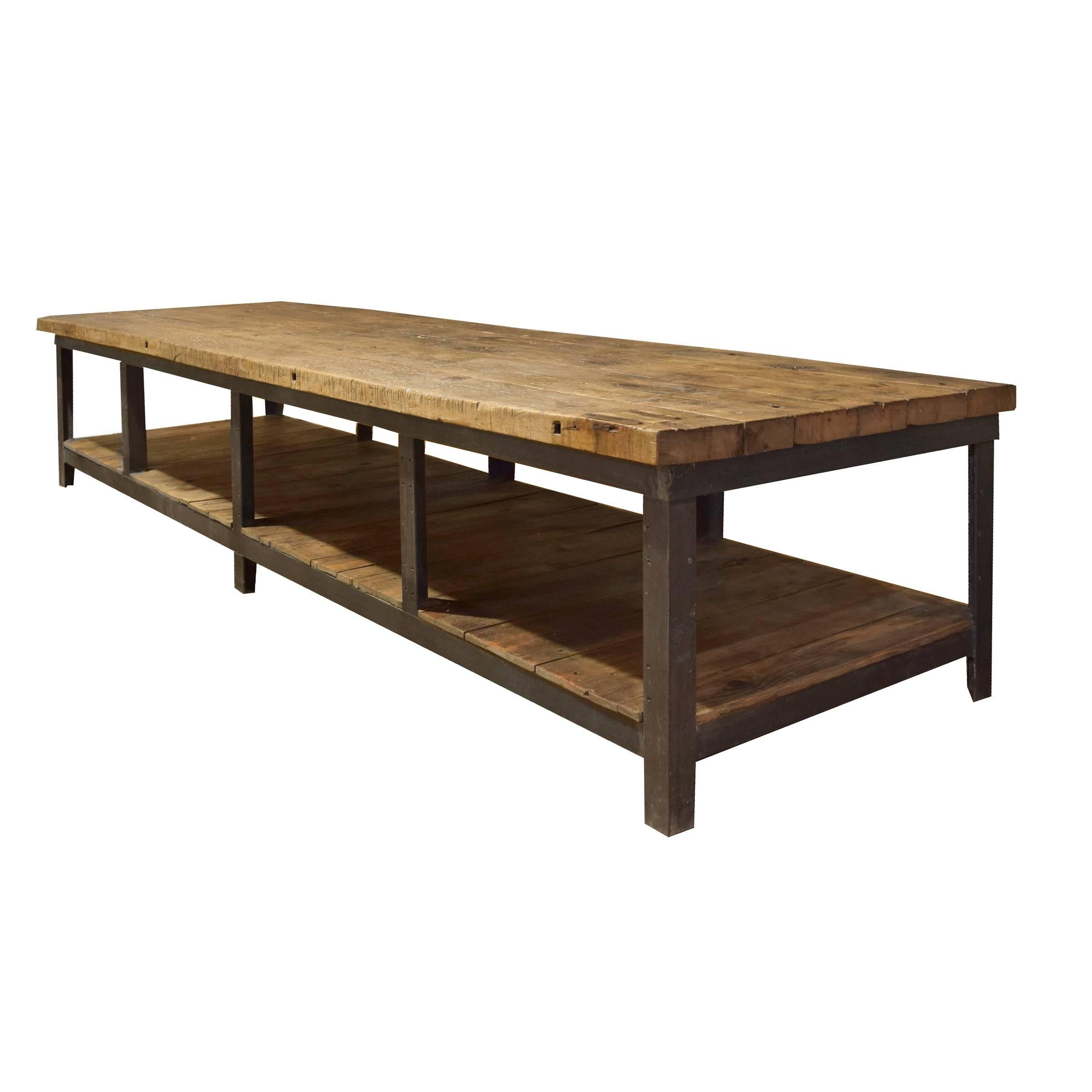 An incredible American Industrial table with an iron frame, well-worn wood top and wood shelf, from the Bethlehem Steel Co., PA.