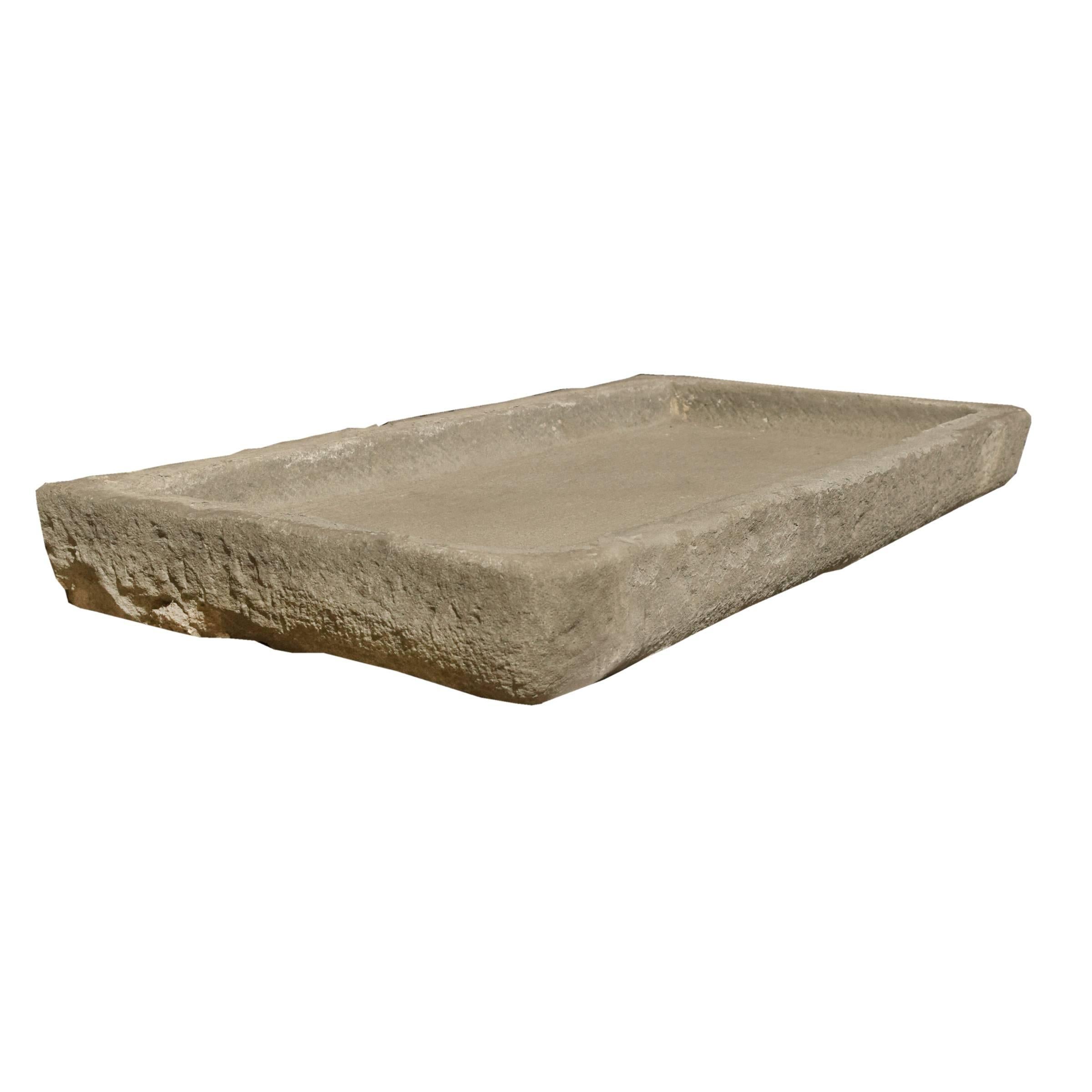 A fantastic Italian carved stone drain board/sink of a rectangular form with low sides and drainage hole, early 19th century.