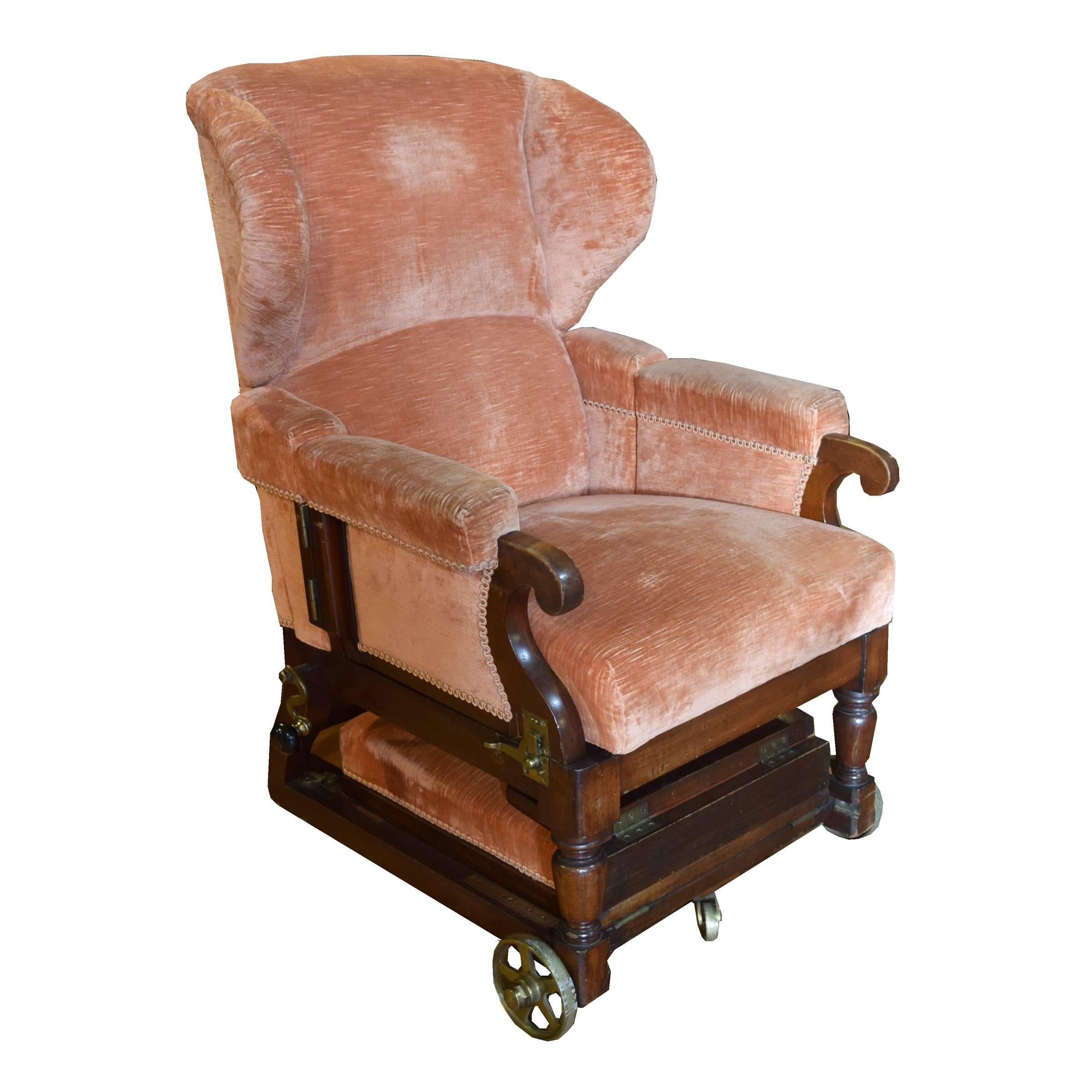 The best quality English adjustable upholstered chair with reclining back, brass wheels, swing out arms and adjustable footrest, late 19th century.
    