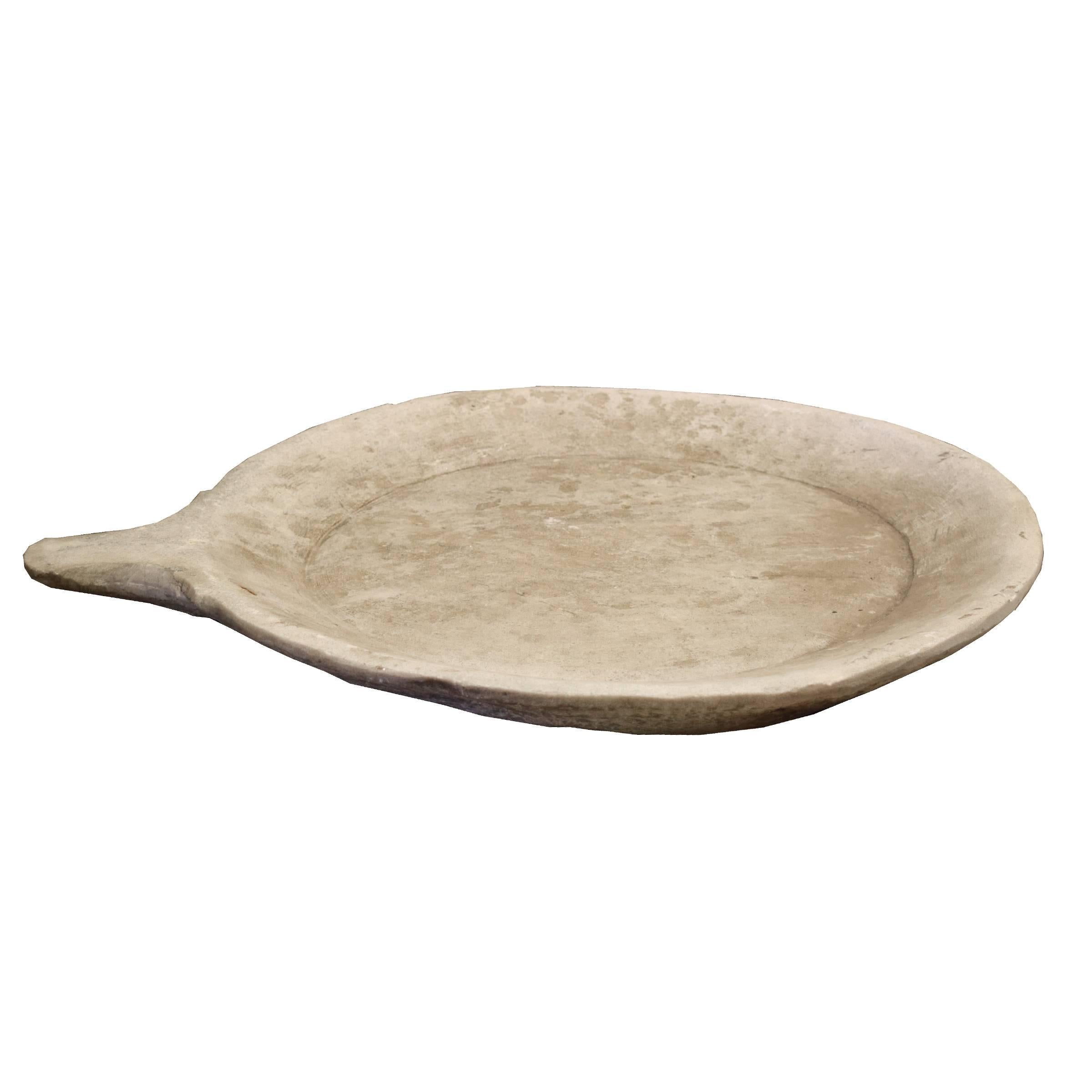 A beautiful round carved marble platter with handle, originally used for baking bread, circa 1900.
Many available. Dimensions vary, each unique.