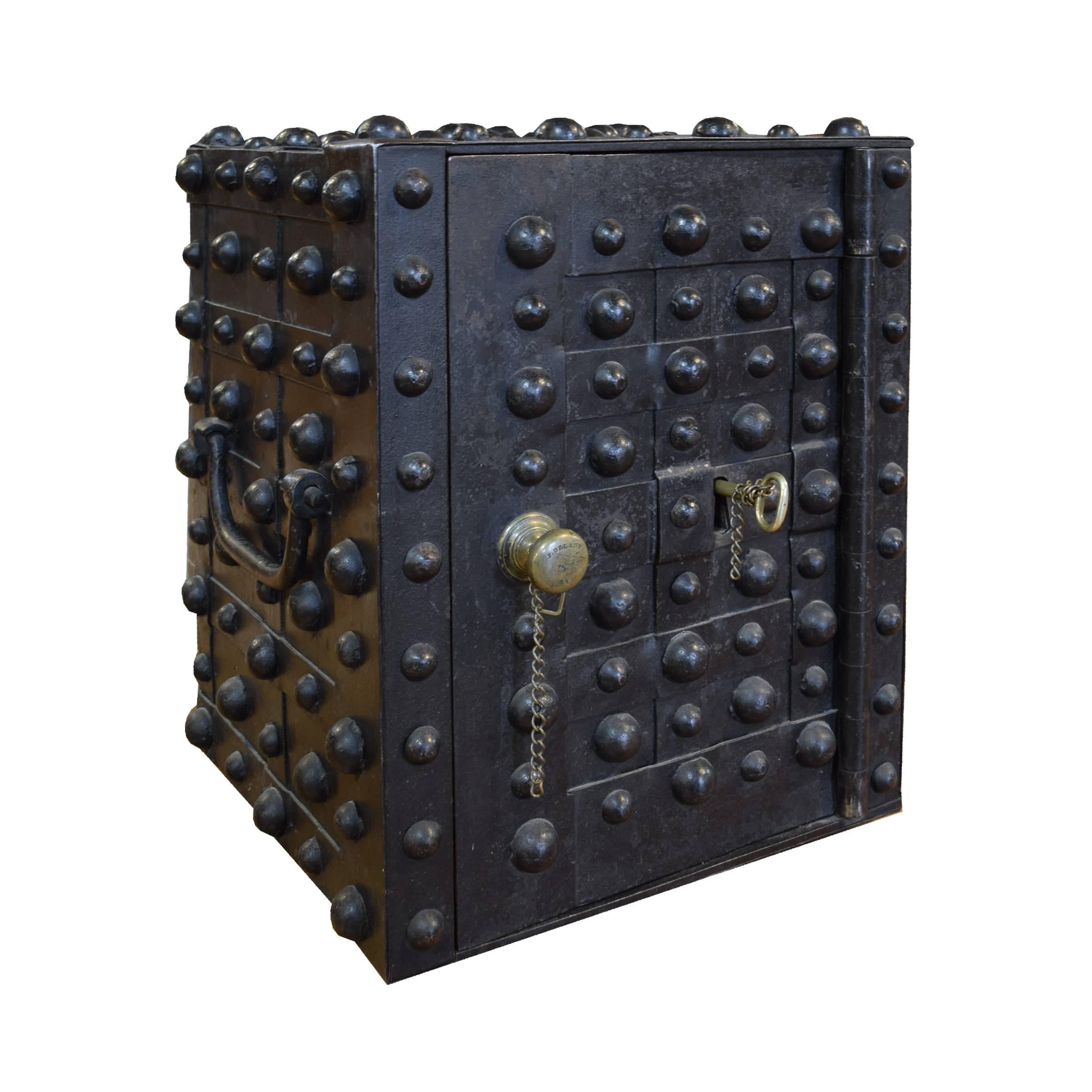 J. Delano of New York iron hobnail safe with two handles and brass knob and key. When the key is removed a panel drops down to hide its location, circa 1830.