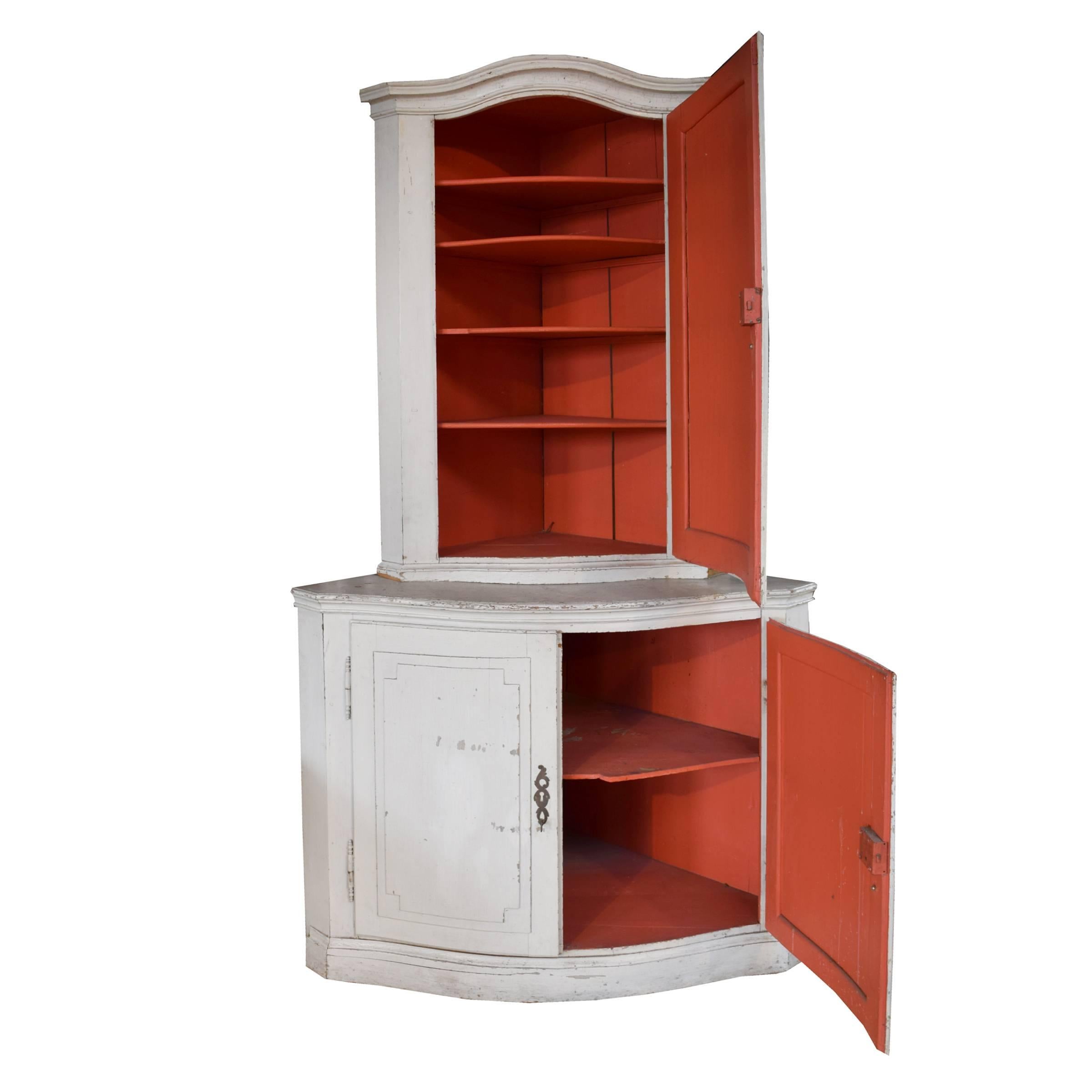 A fantastic and very old German two-tier corner cabinet with a wonderful grey chalky painted exterior and red painted interior with shelves, circa 1800.