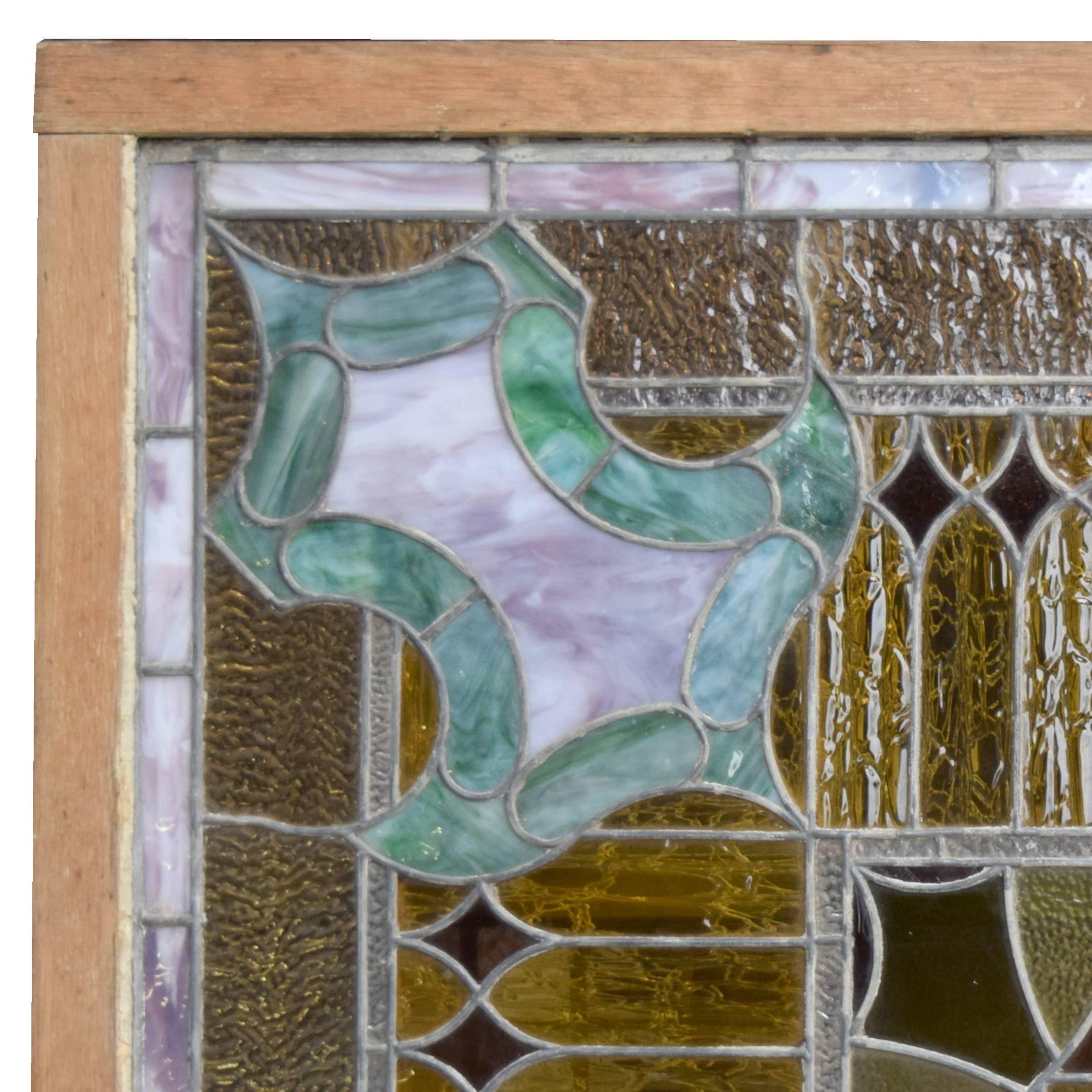 An impressive American square stained glass window in a wood frame.