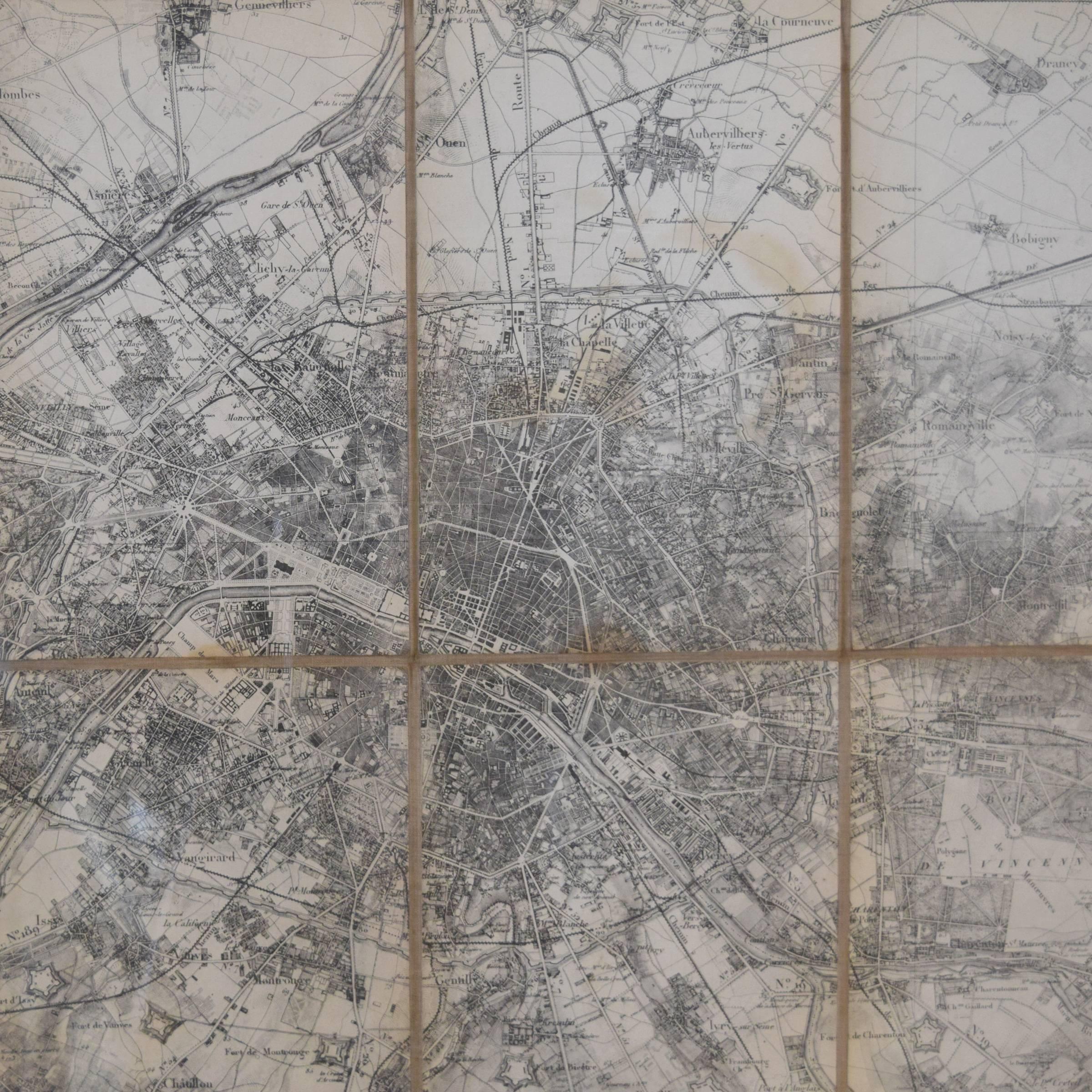 A folding pocket map of Paris from the French war department, 1839, mounted on silk in a new frame.
       