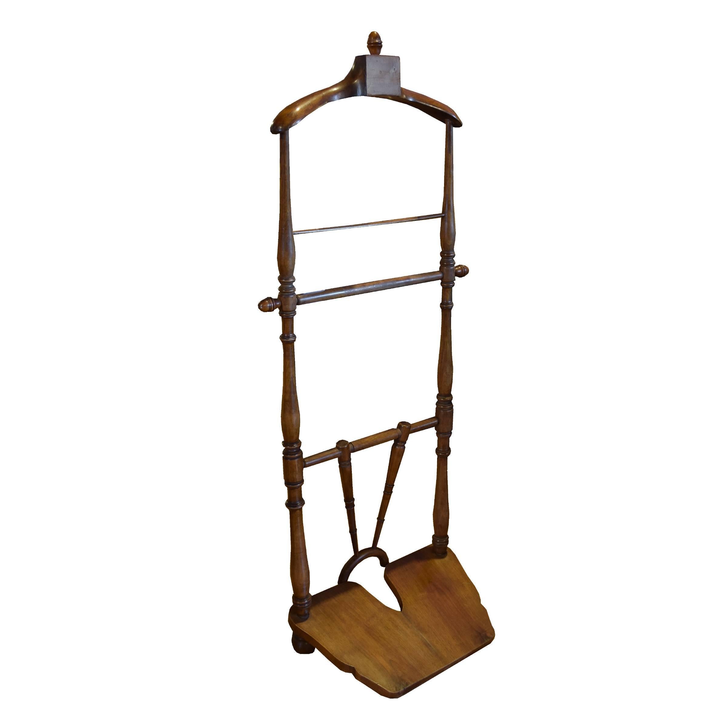 An Italian wood gentleman's valet stand with coat and pant hangers and a boot assist, circa 1920.
 