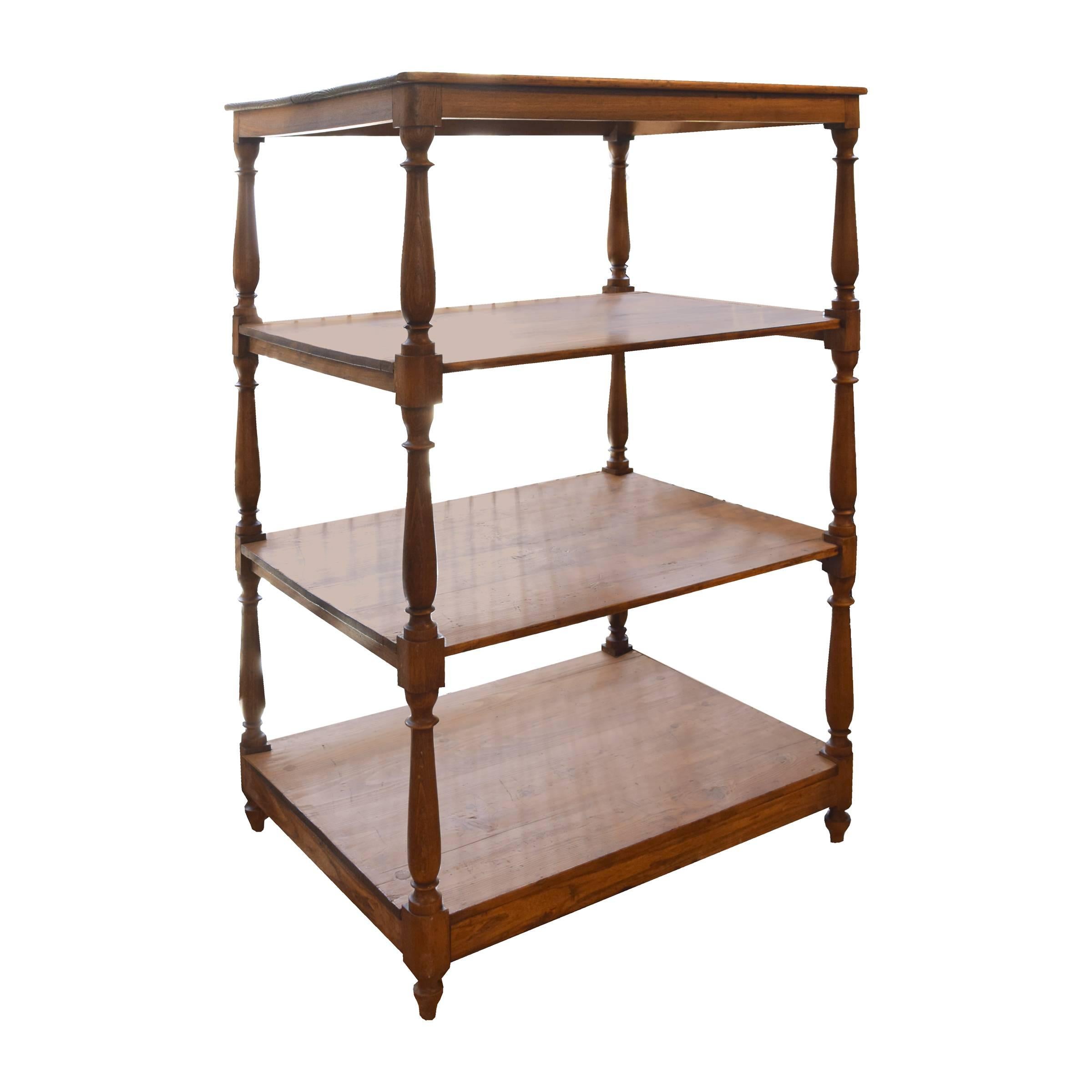 A Swiss four-tier pine display shelf with turned legs, from a Swiss chocolate shop.