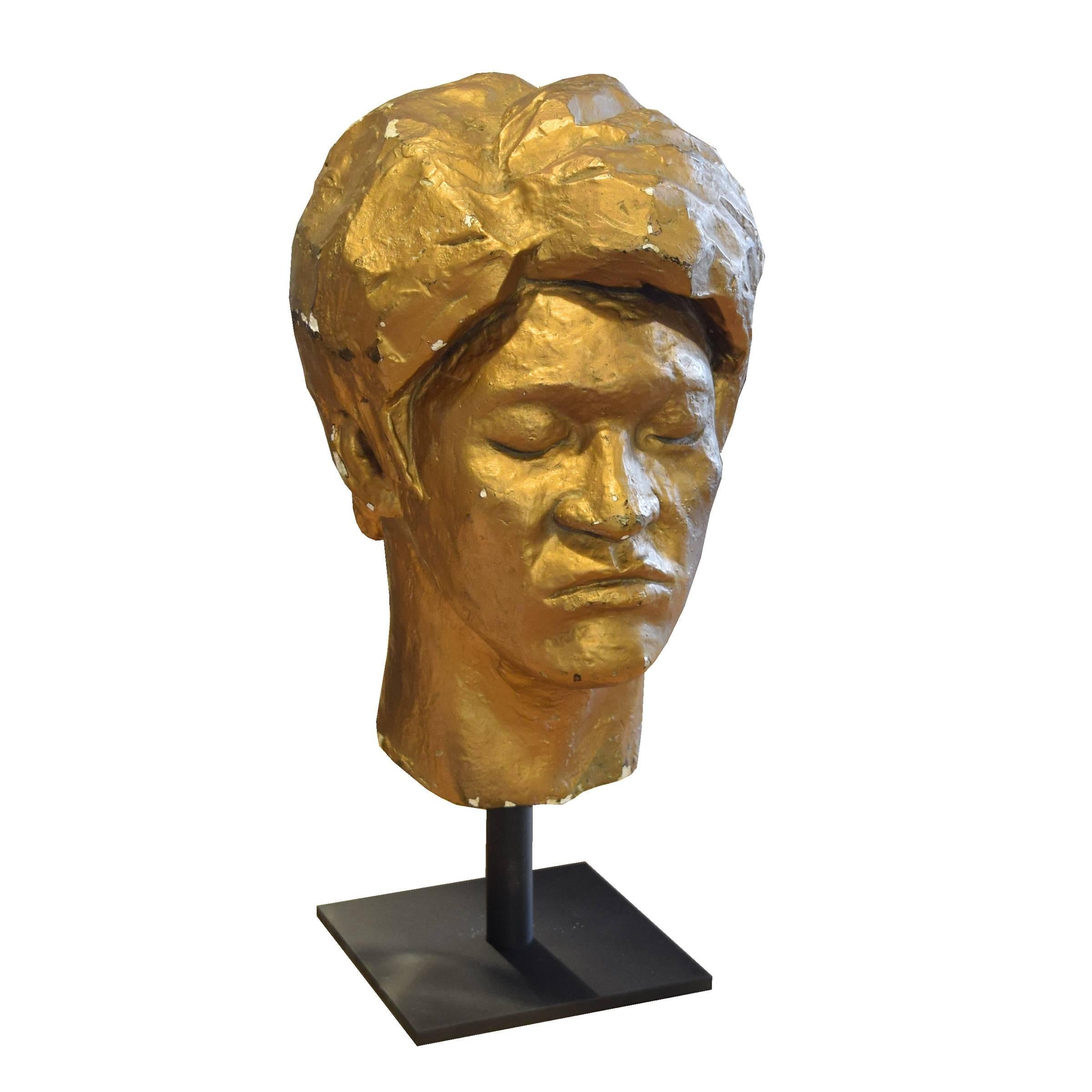 An artist composition bust with gold paint, circa 1960, on a custom mount.