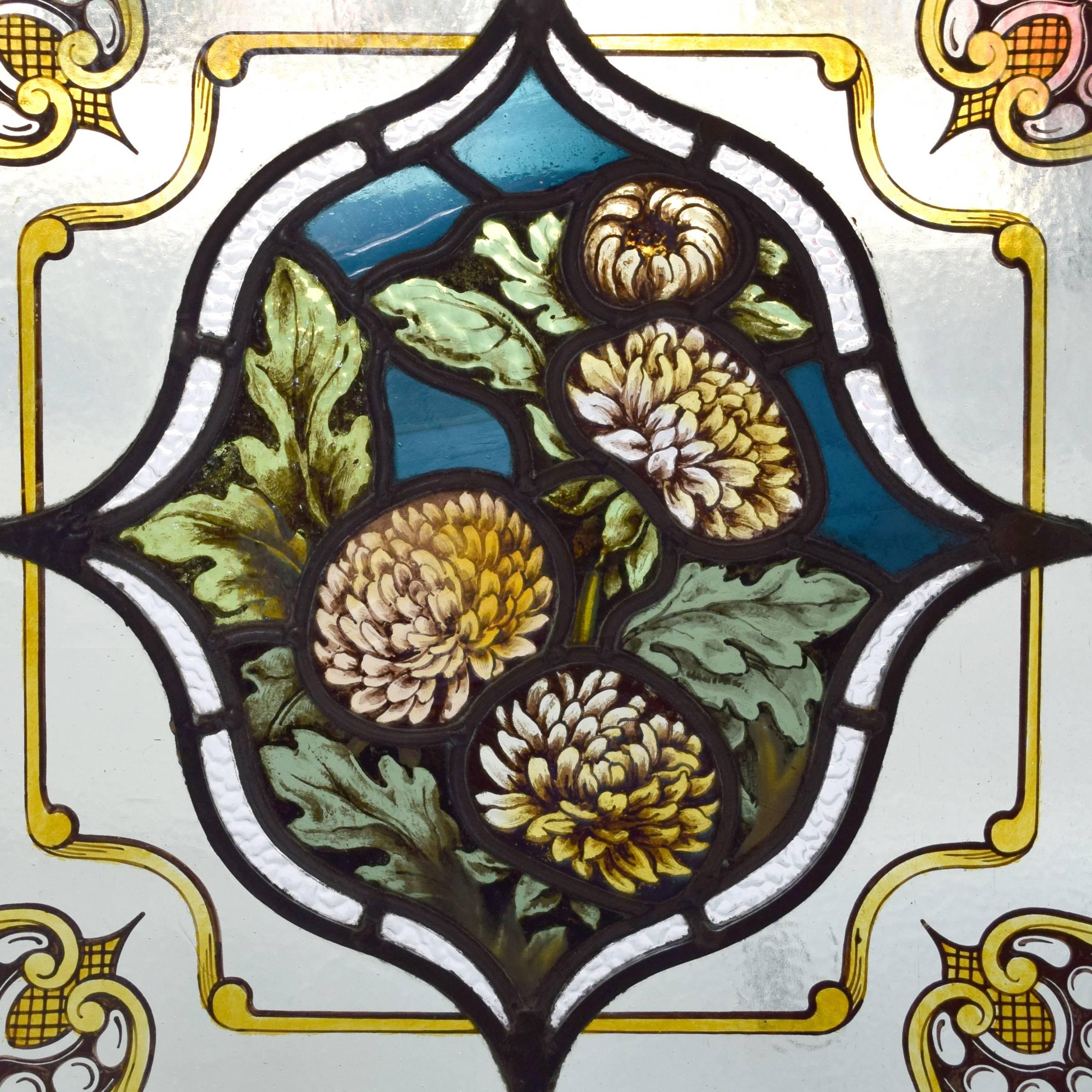 A fantastic English art glass window with a central medallion of chrysanthemums, circa 1880.