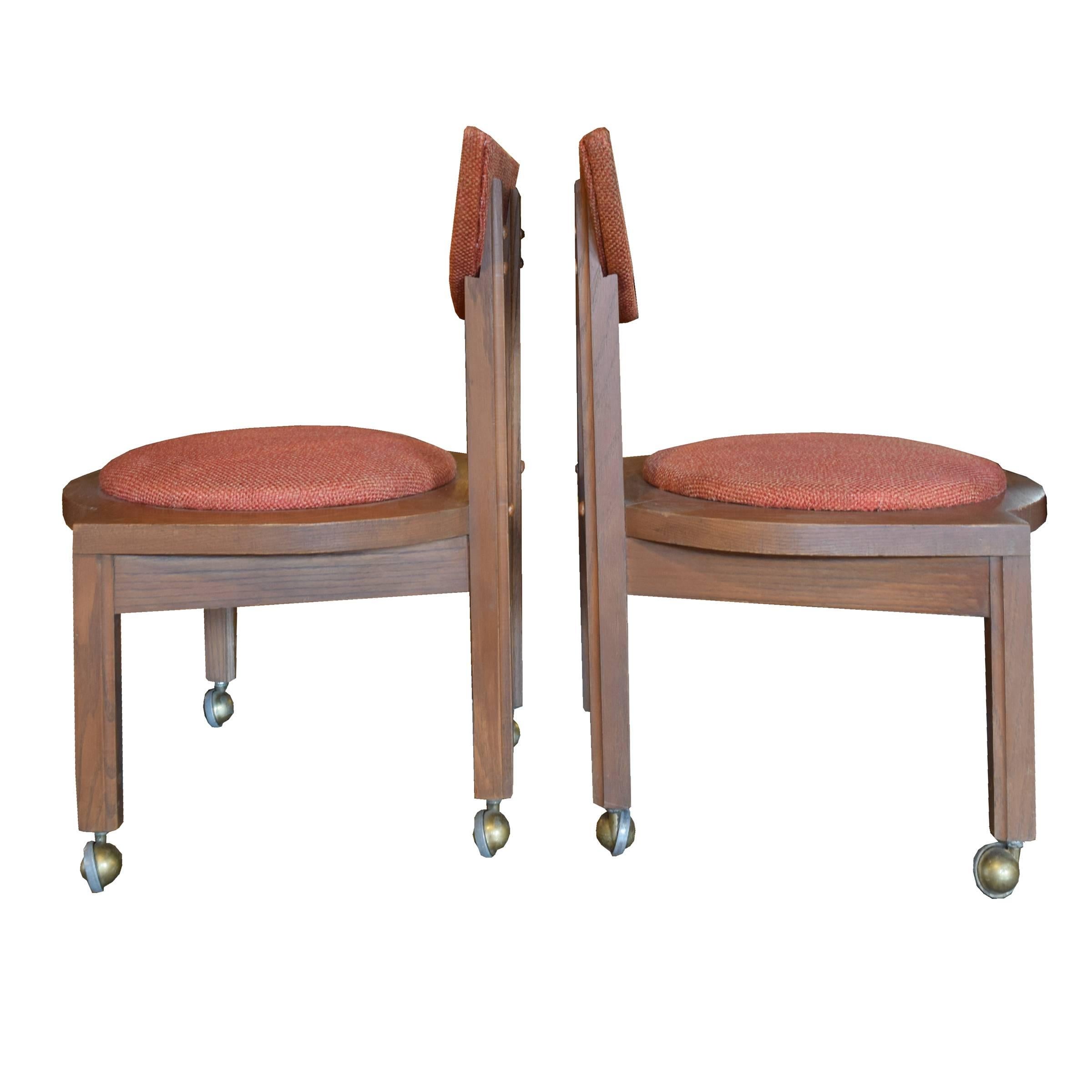 A pair of Frank Lloyd Wright designed side chairs with original upholstery and casters from the Riverview Terrace Restaurant in Spring Green, WI. The restaurant, built in 1953, is across the street from Wright's Wisconsin home and studio, Taliesin,