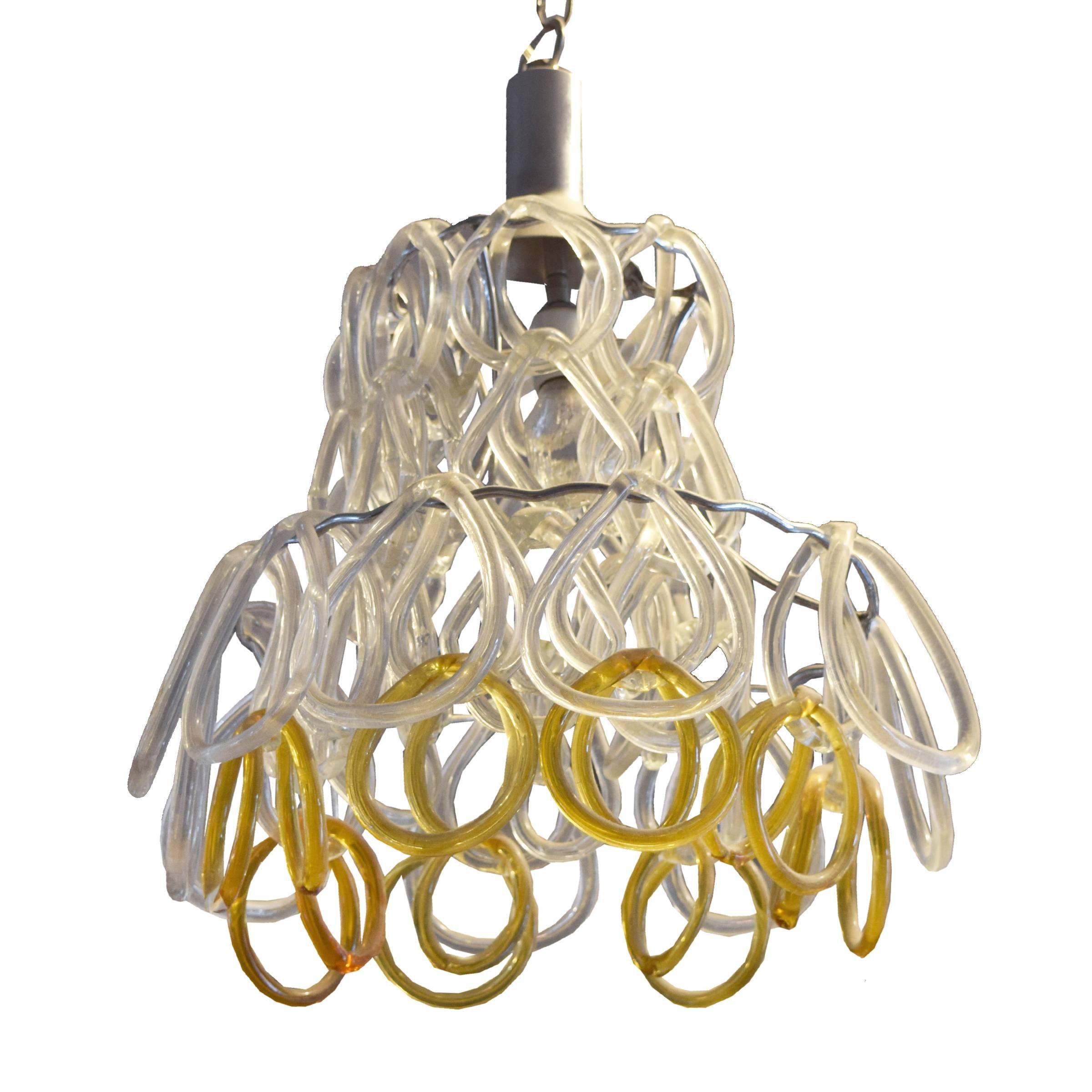 A funky Italian Mid-Century light fixture with four tiers of interlocking slumped glass rings.
Height listed does not include chain.