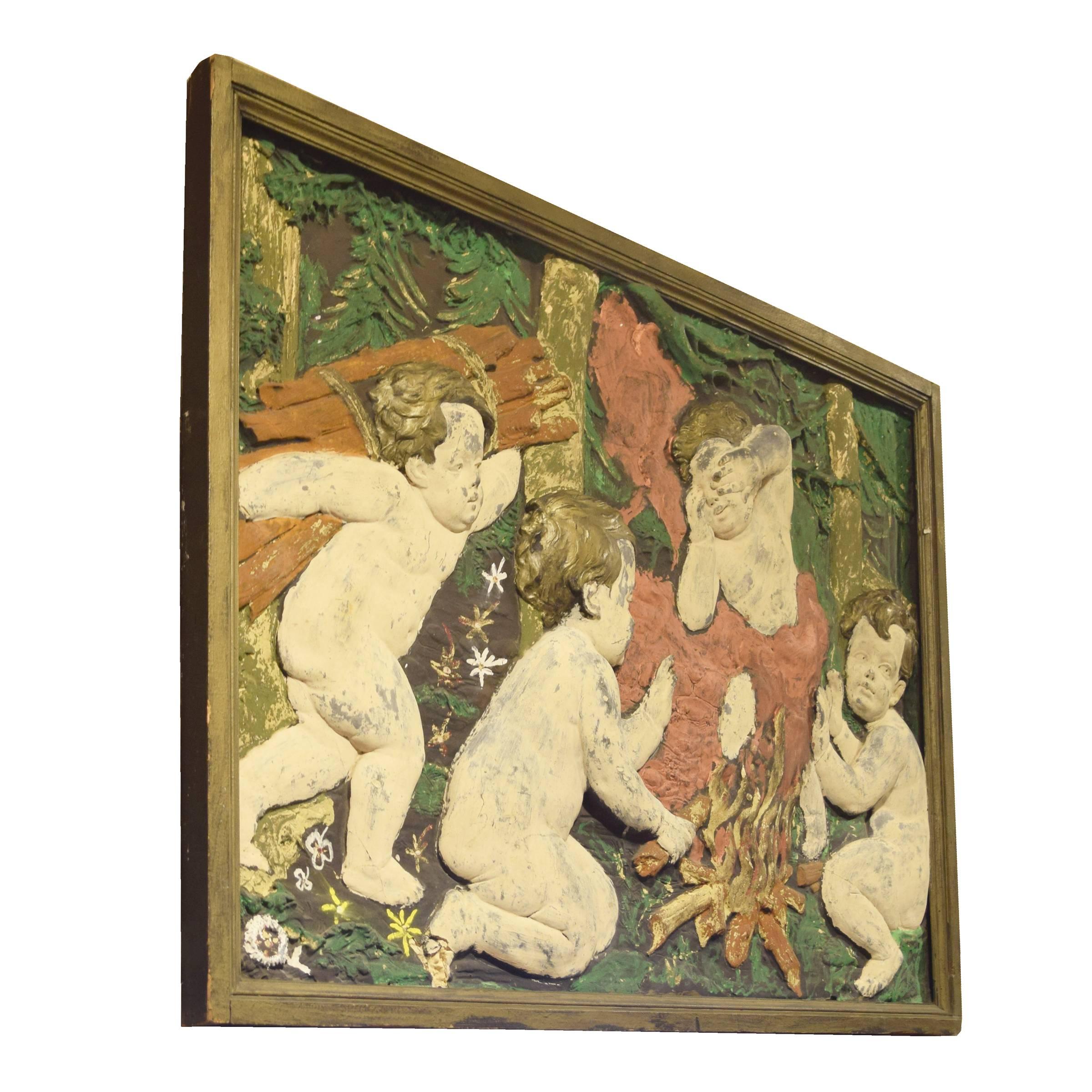 An Argentine painted composition relief panel depicting four cherubs, around a fire.
 