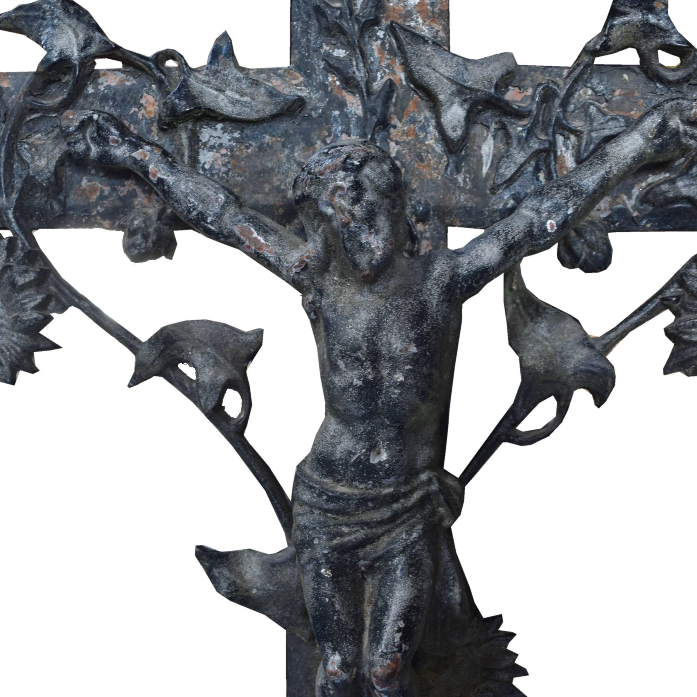 A French cast iron crucifix with a sunflower motif, circa 1900.