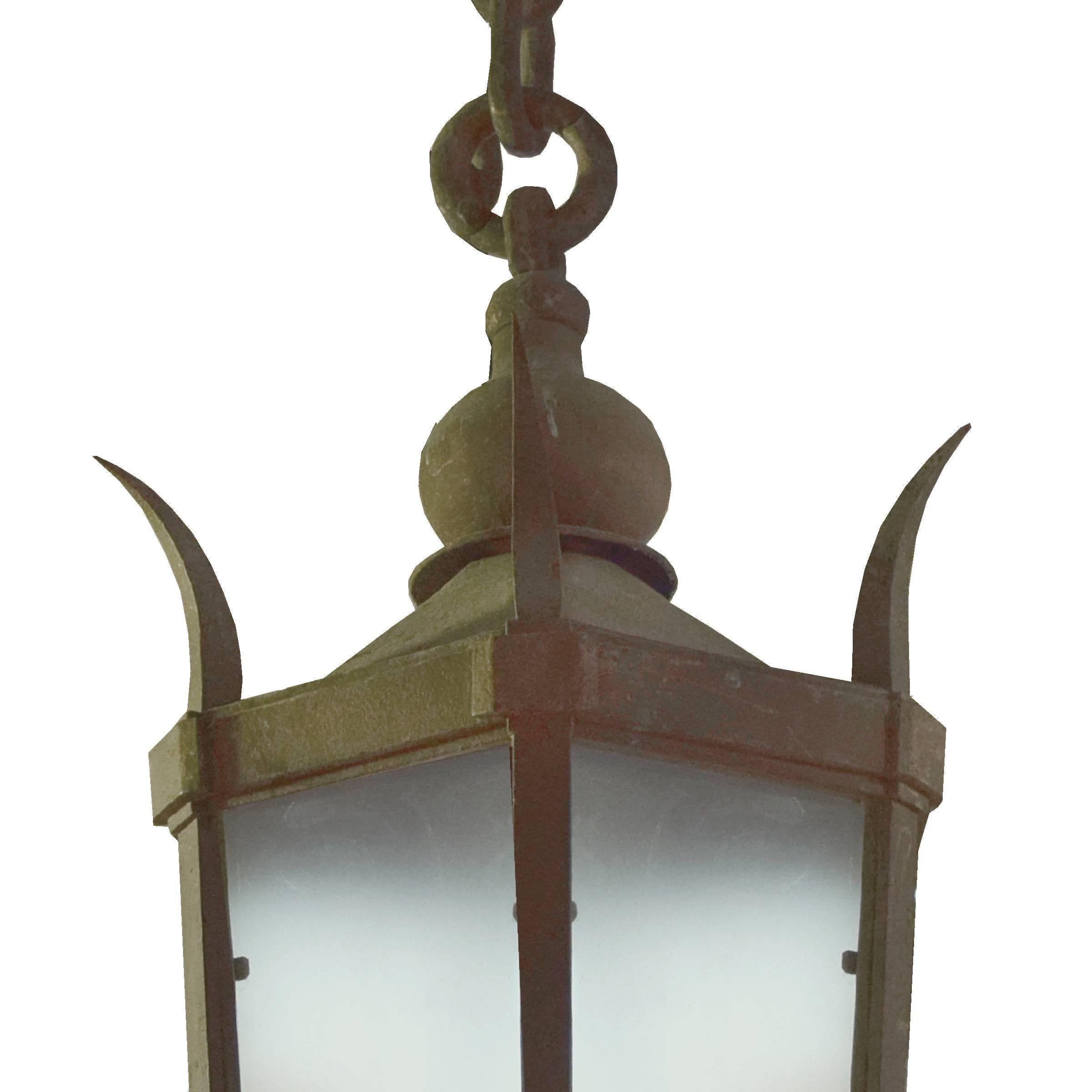 A wonderful Argentine wrought iron light fixture with six frosted glass shades from the estate of Jose Thenee, on a long heavy chain.
Requires re-wiring.