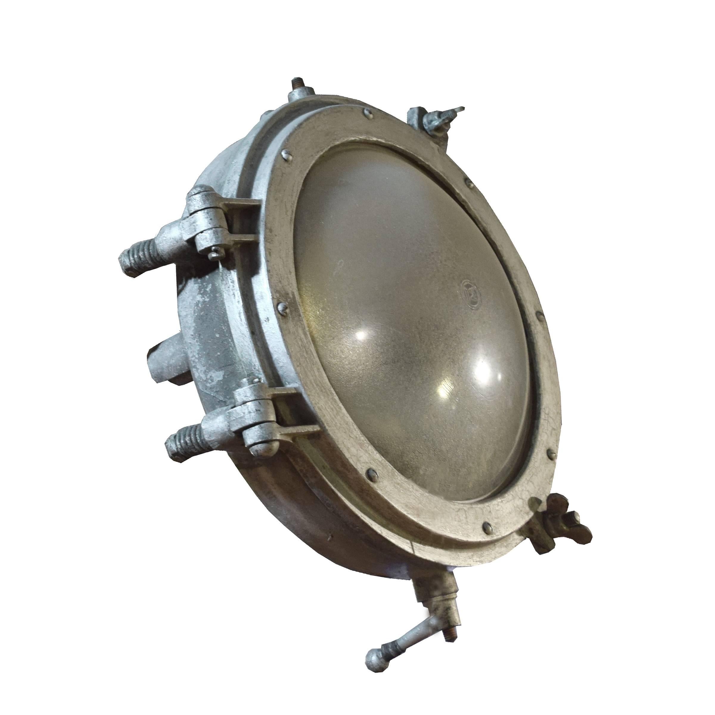 A funky American industrial round light fixture with a convex frosted glass shade.
Requires re-wiring.