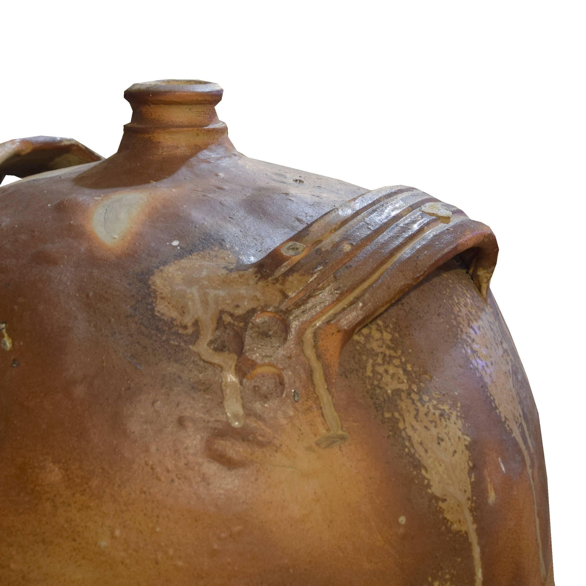 A large French hand-built ceramic wine vessel with handles, a spigot, and a cool glaze, circa 1900.
 