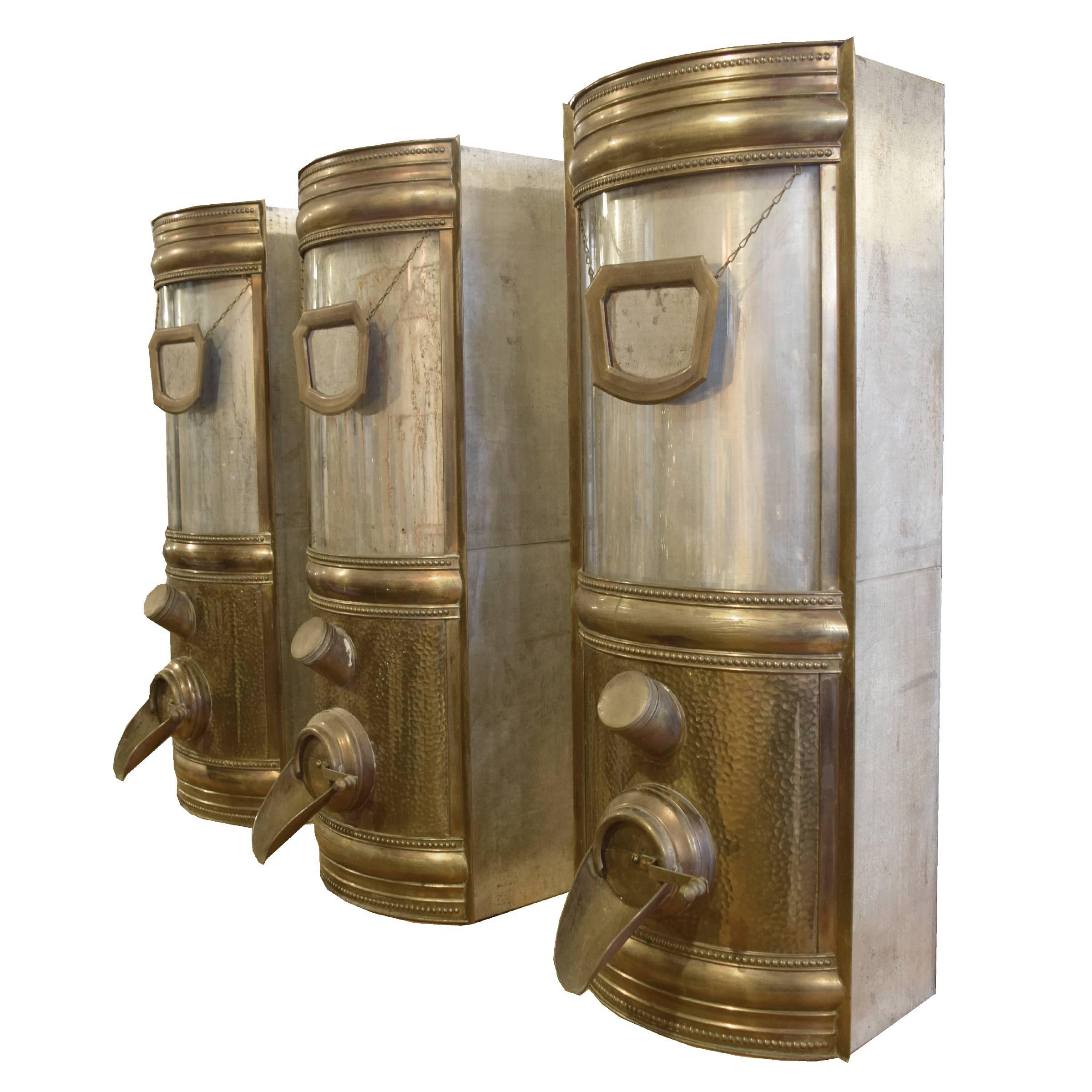 The best set of six brass and glass coffee beans dispensers with a bean display window, brass framed name tag holder, spout, and scoop, circa 1900.